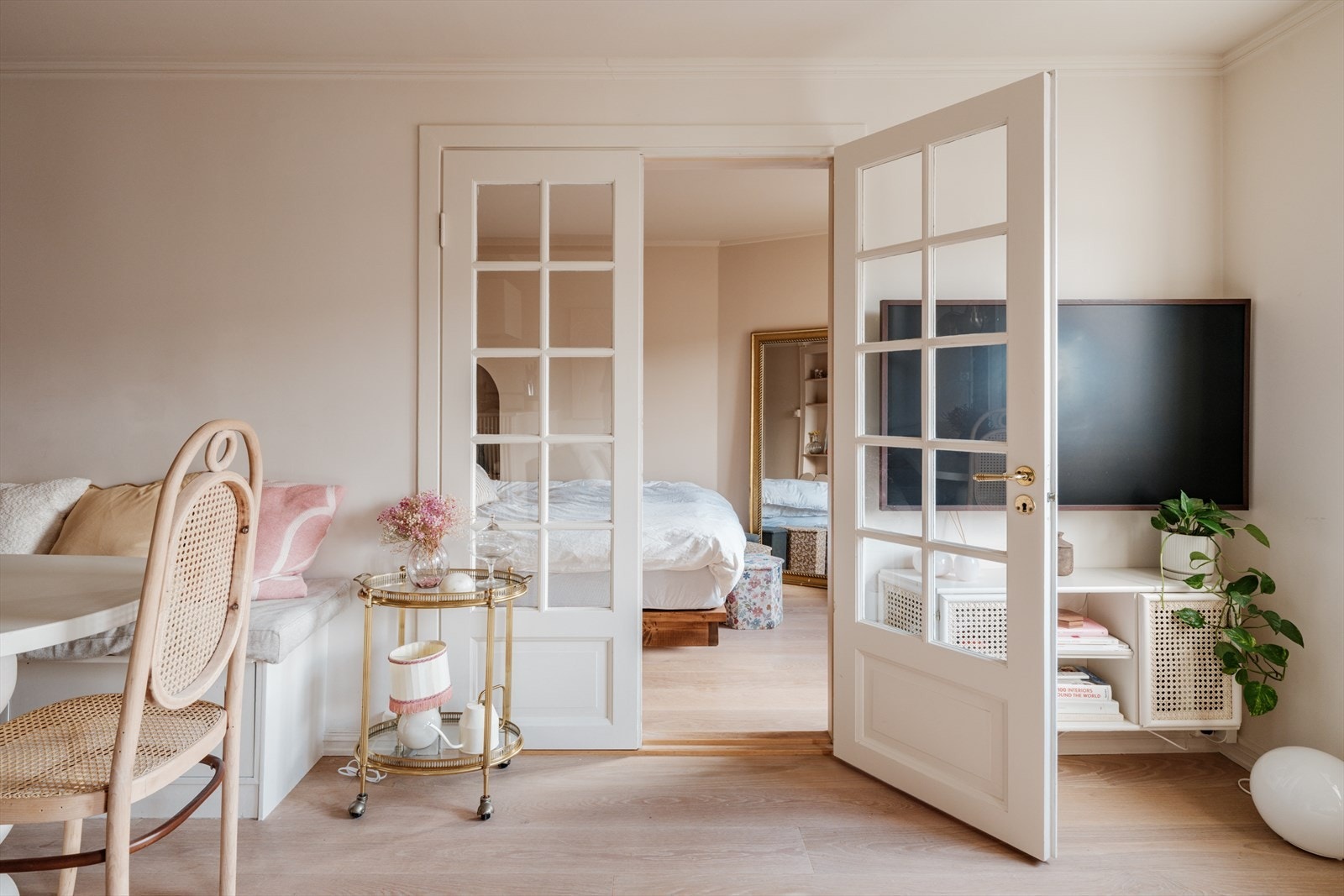 Doble fløydører åpner opp til leilighetens soverom, som fylles av naturlig dagslys. Galleribilde