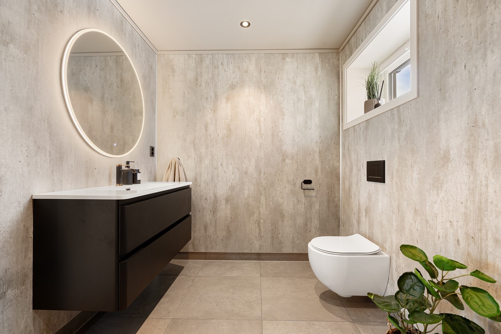 Badet har en lun fargepalett, gulvvarme og downlights som gir en rolig og innbydende stemning. Galleribilde