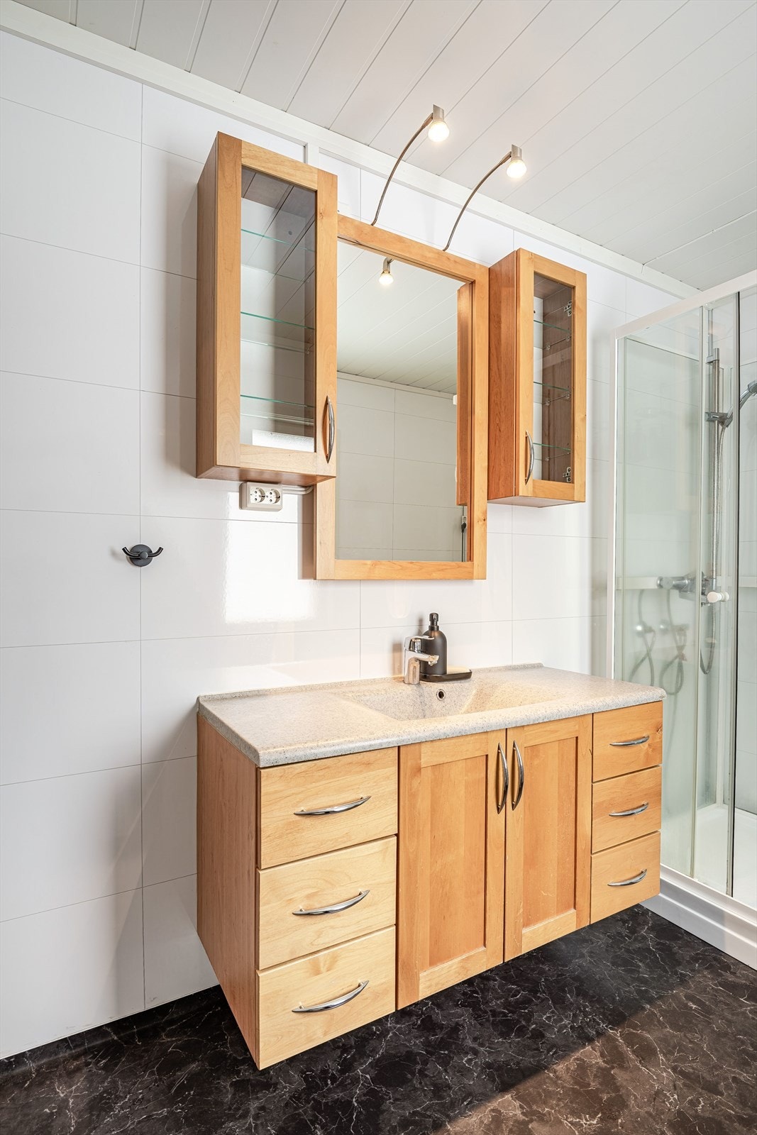 Innredning med servant og speilskap, dusjkabinett og toalett. Galleribilde