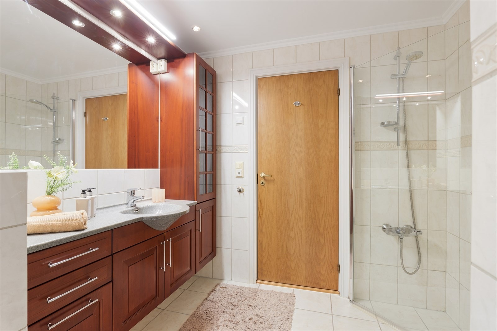 Leiligheten har et romslig bad som er helfliset og utstyrt med dusj og opplegg for vaskemaskin. Galleribilde