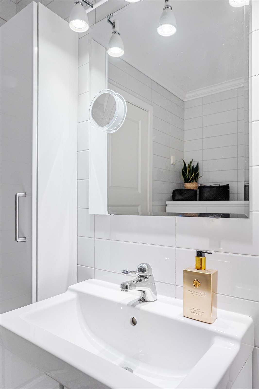 Badet er innredet med hvit baderomsinnredning og dusjkabinett Galleribilde