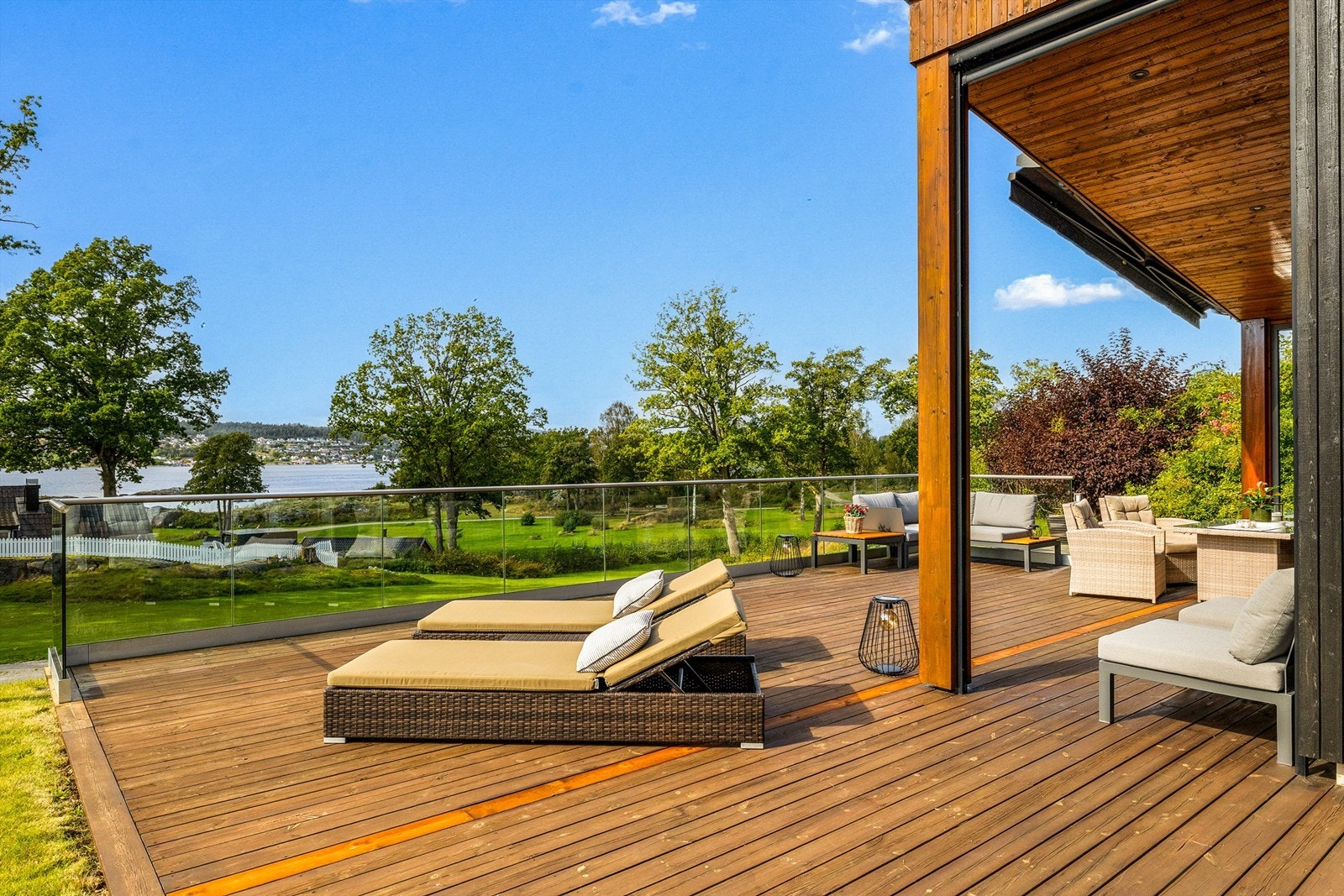 UTEPLASSEN. Utenfor hytta er et en stor terrasse med plass til spisebord, sofagruppe og solstoler. Den store terrassemarkisen er elektrisk og skjermer for sola når man ønsker det. Galleribilde