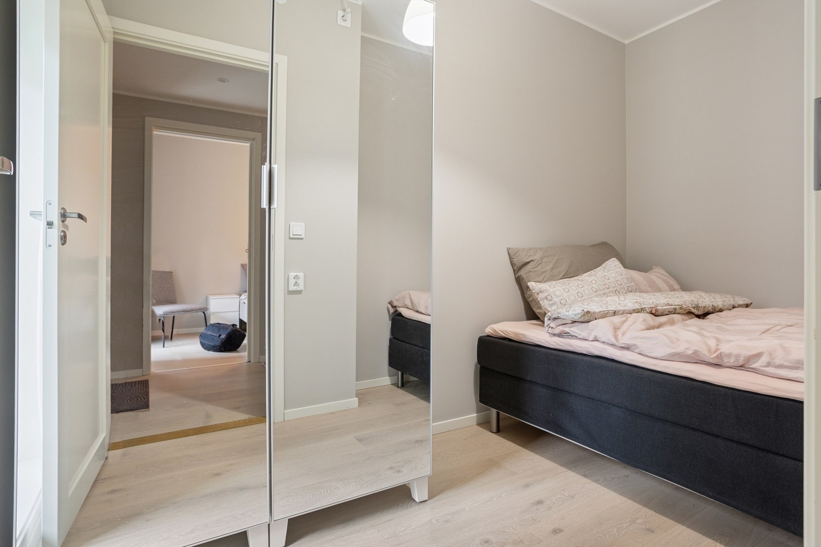 Det andre soverommet er også romslig og har fint plass til seng og skrivepult eller annen innredning. Rommet er i tillegg utstyrt med et garderobeskap med speildører, som både gir smart oppbevaring og bidrar til å forsterke romfølelsen. Galleribilde