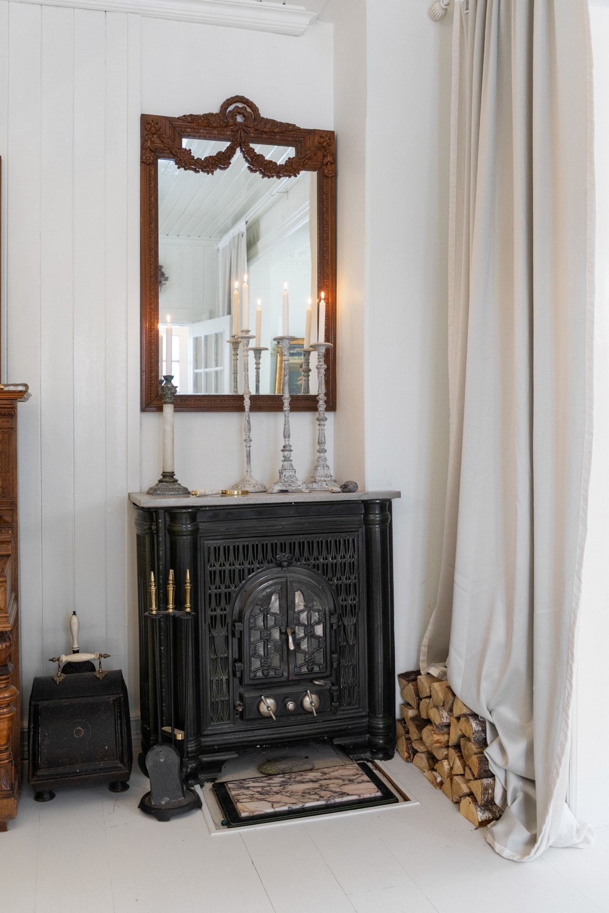 I hallen står en eldre ved-/koksovn som bidrar til å understreke boligens historiske preg. Galleribilde