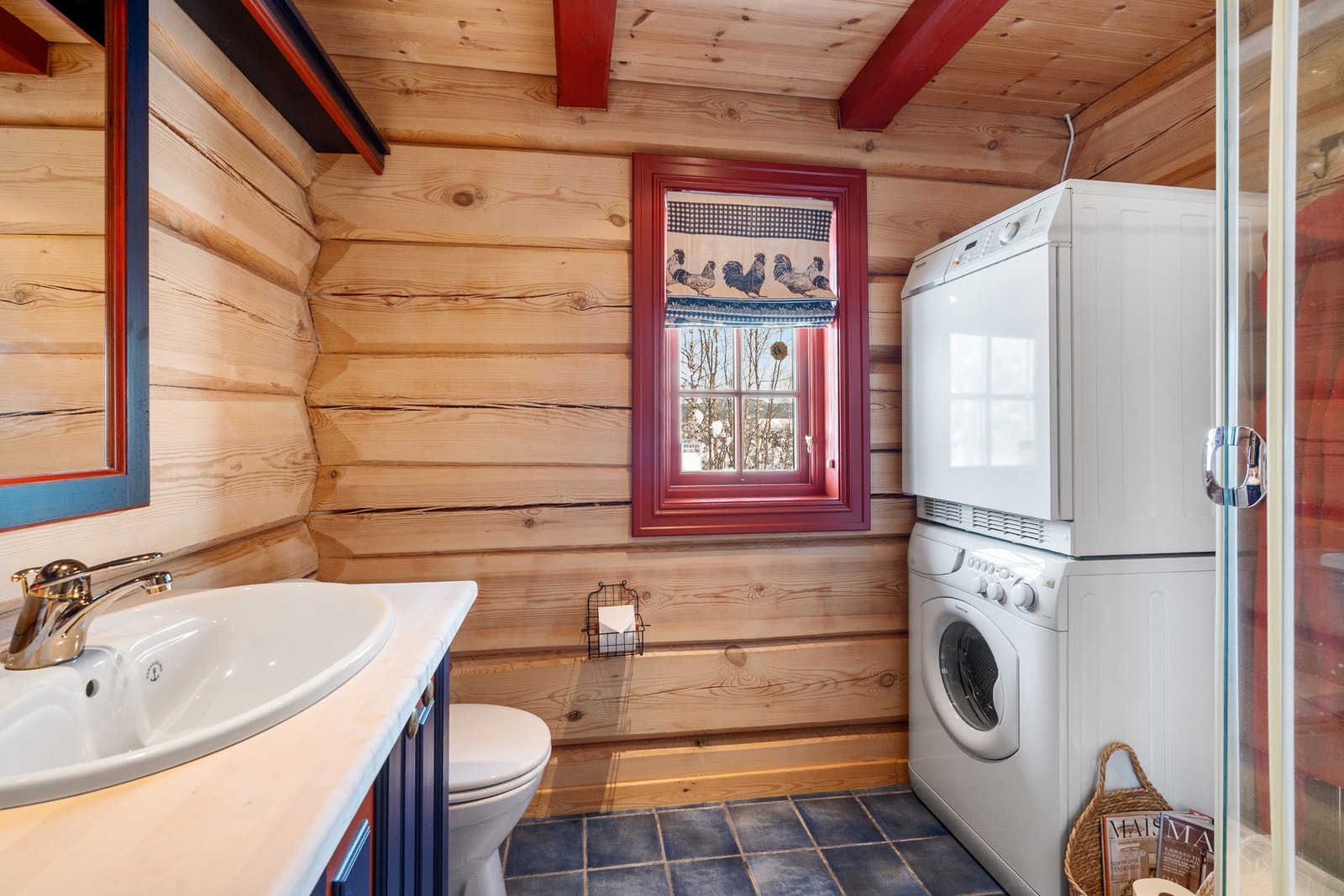 Det andre badet fungerer også som vaskerom, med opplegg for vaskemaskin og tørketrommel. Rommet har også flislagt gulv med varmekabler og frittstående dusjkabinett, gulvmontert toalett og servant Galleribilde