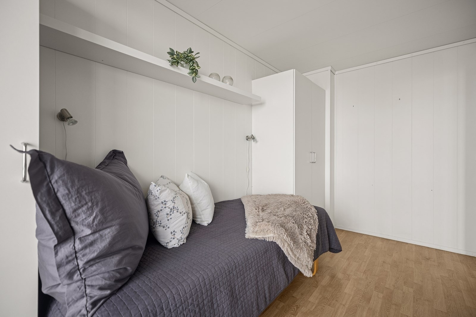 Rommet har laminatgulv og malte plater på veggene. Galleribilde