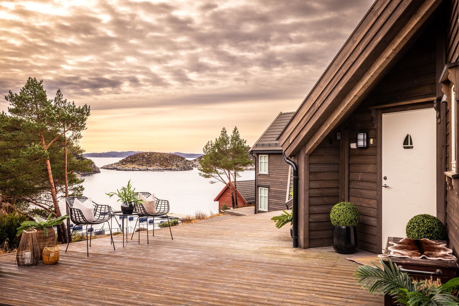 Fra terrasse ser man ned på båtplass og felles naust hvor man disponerer en liten bod til fiskeutstyr m.m Galleribilde