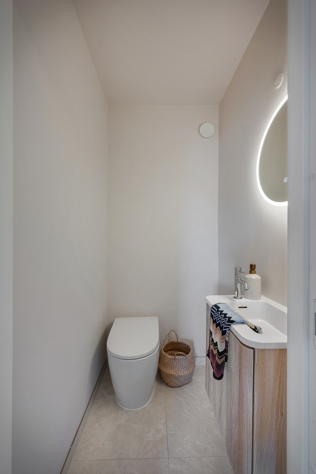 Like ved badet ligger wc-rommet som ble oppusset i 2025 med store fliser på gulv og med en lekker innredning. Galleribilde