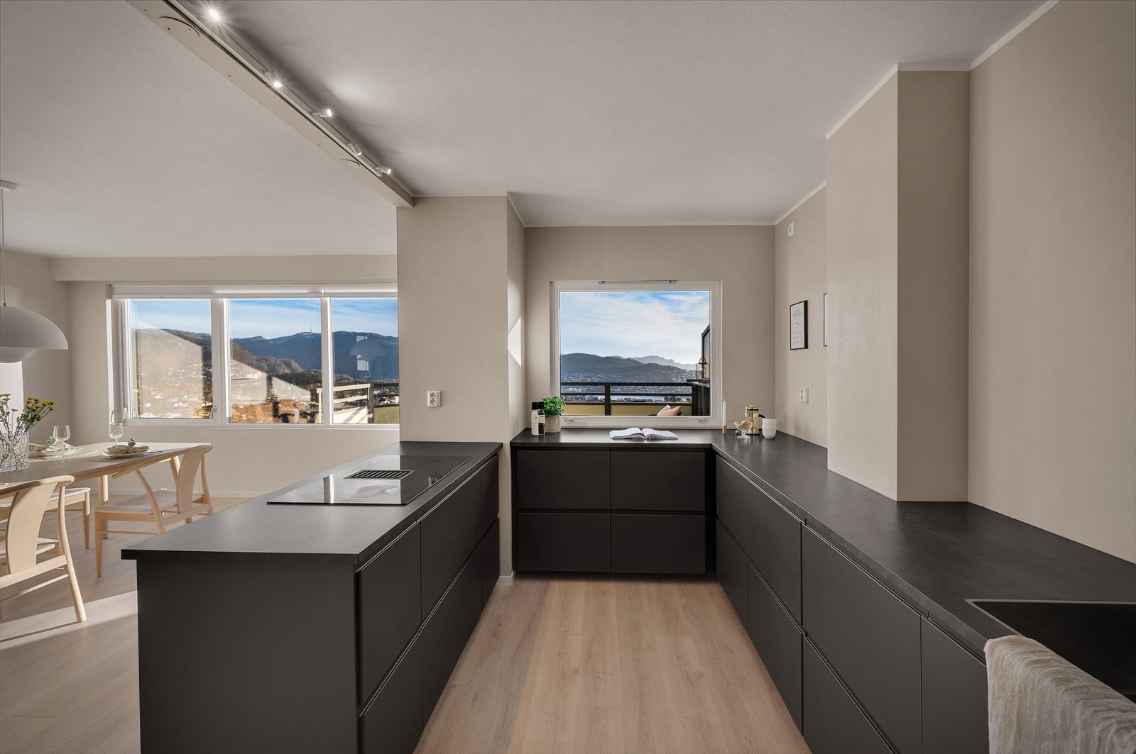 Stort vindu over kjøkkenbenken, vendt ut mot balkong, muliggjør sosialisering med gjestene, selv om man står på kjøkkenet og kokkelerer. Galleribilde