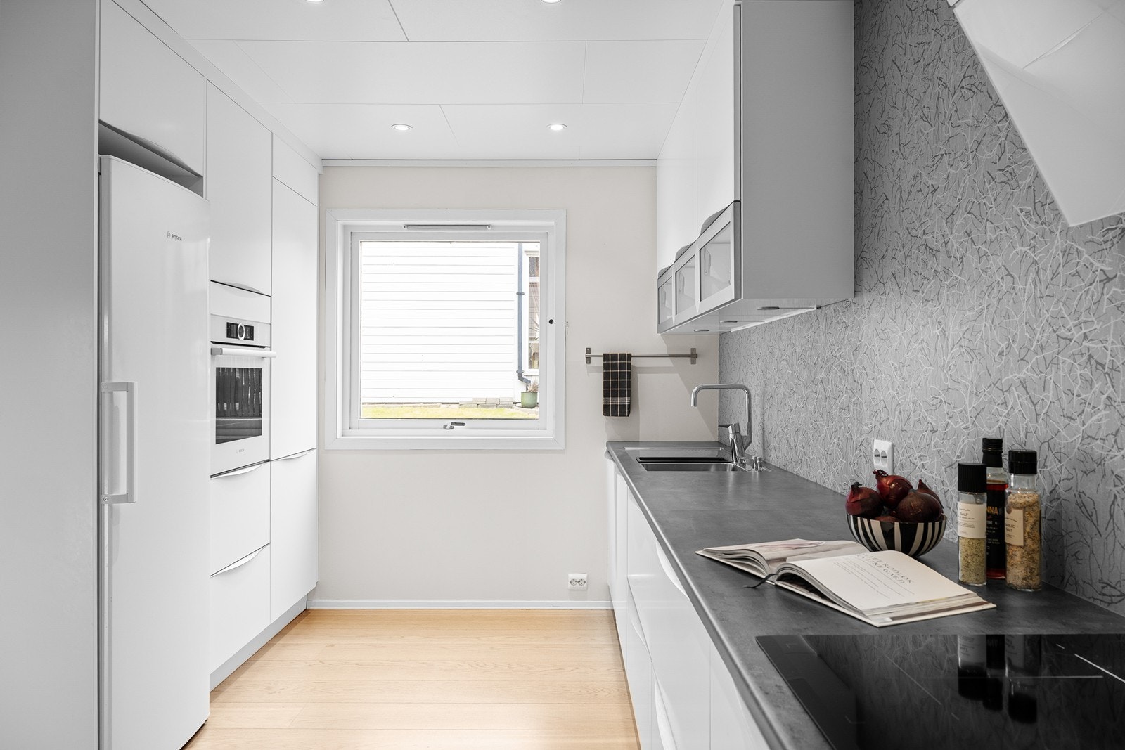 Integrert koketopp, oppvaskmaskin og komfyr med delvis integrert kjøleskap. Galleribilde