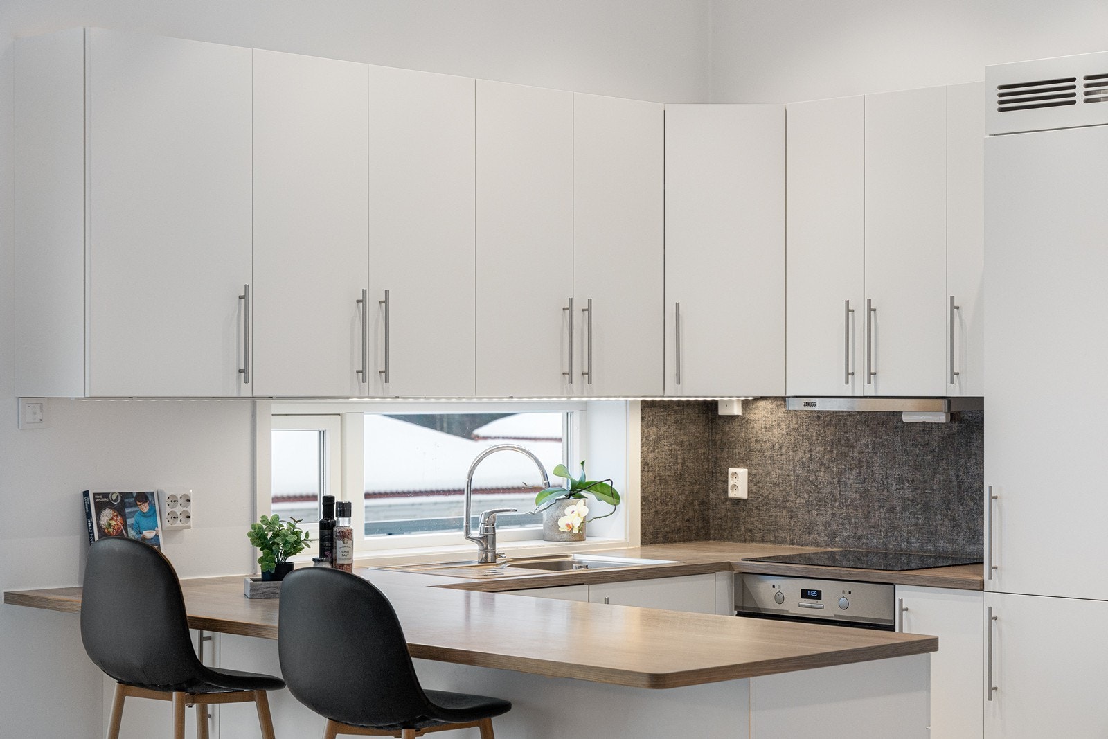 Ut mot stuen er det en stor barløsning med rom for flere sitteplasser. Galleribilde