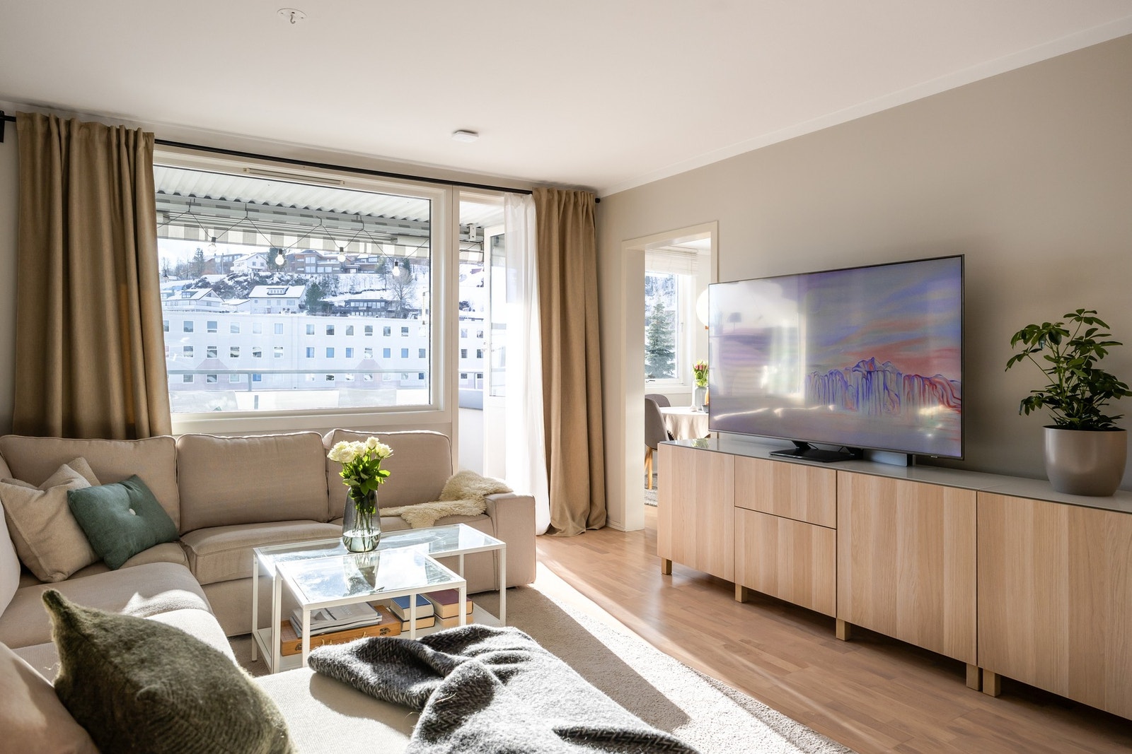 Vinduskledd vegg mot sør slipper til rikelig med dagslys inn i stua og på kjøkkenet. Galleribilde