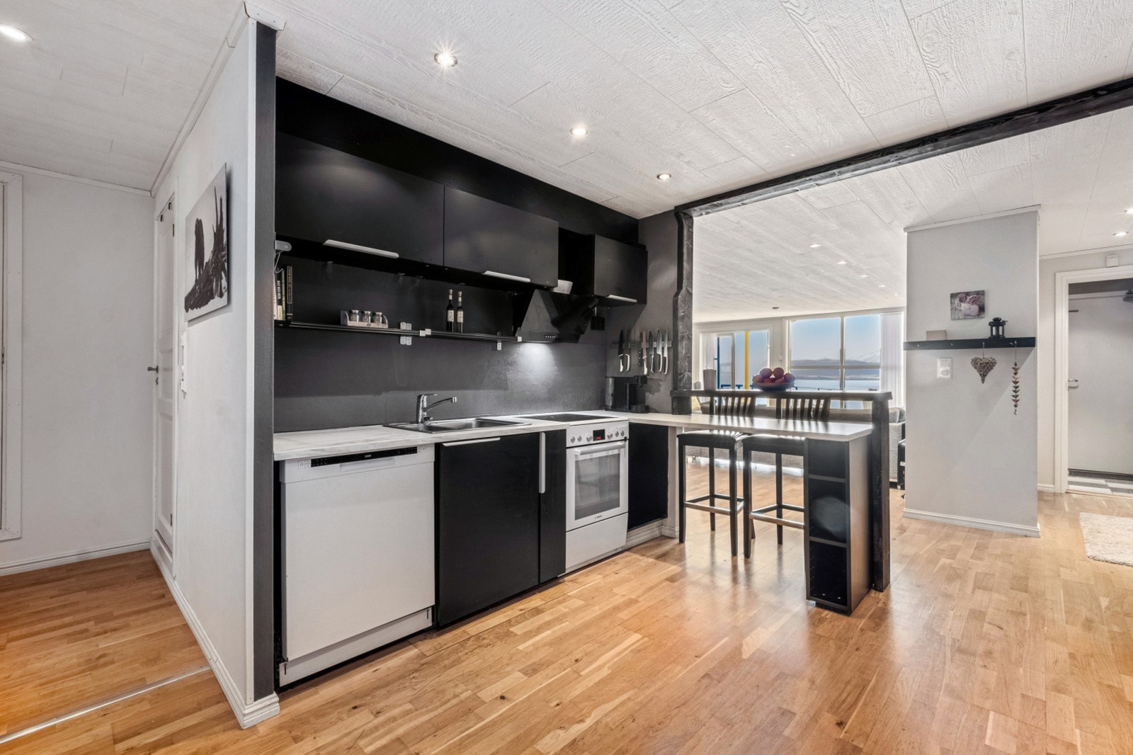 Innredningen gir en hyggelig stemning i kjøkkenet med barløsning og god plass for kokkelering Galleribilde