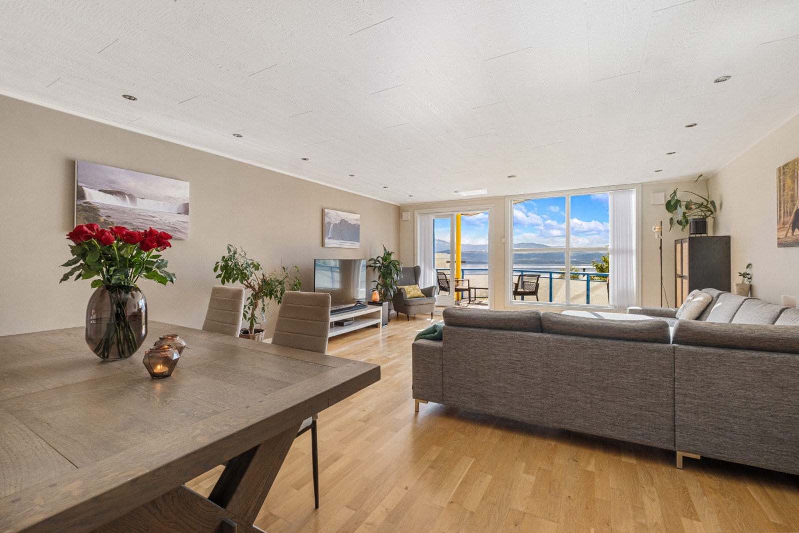 Stuen har naturlige soner for innredning med spisebord og sofa. Galleribilde