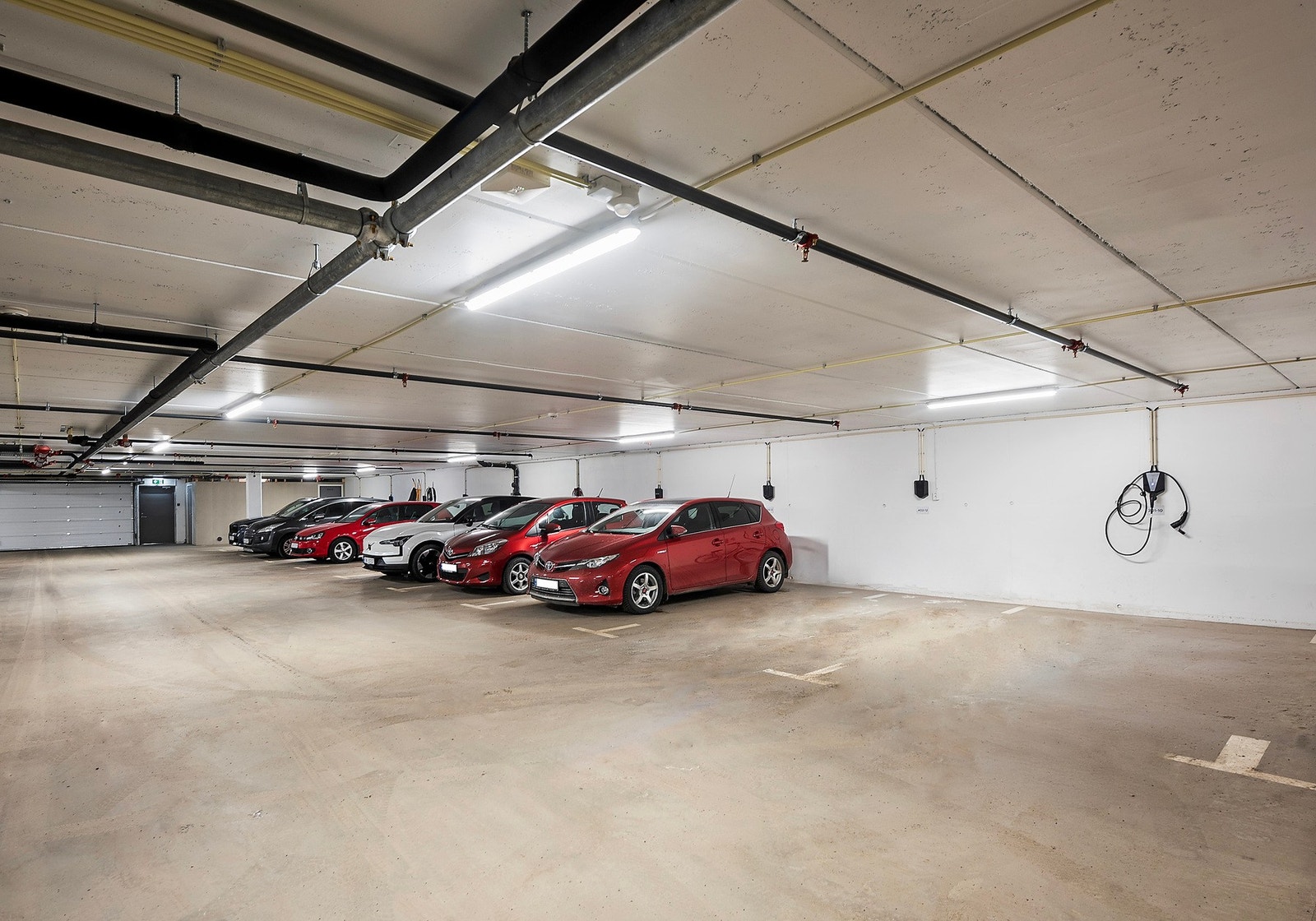 Parkeringsplass med el-billader i felles garasjeanlegg Galleribilde