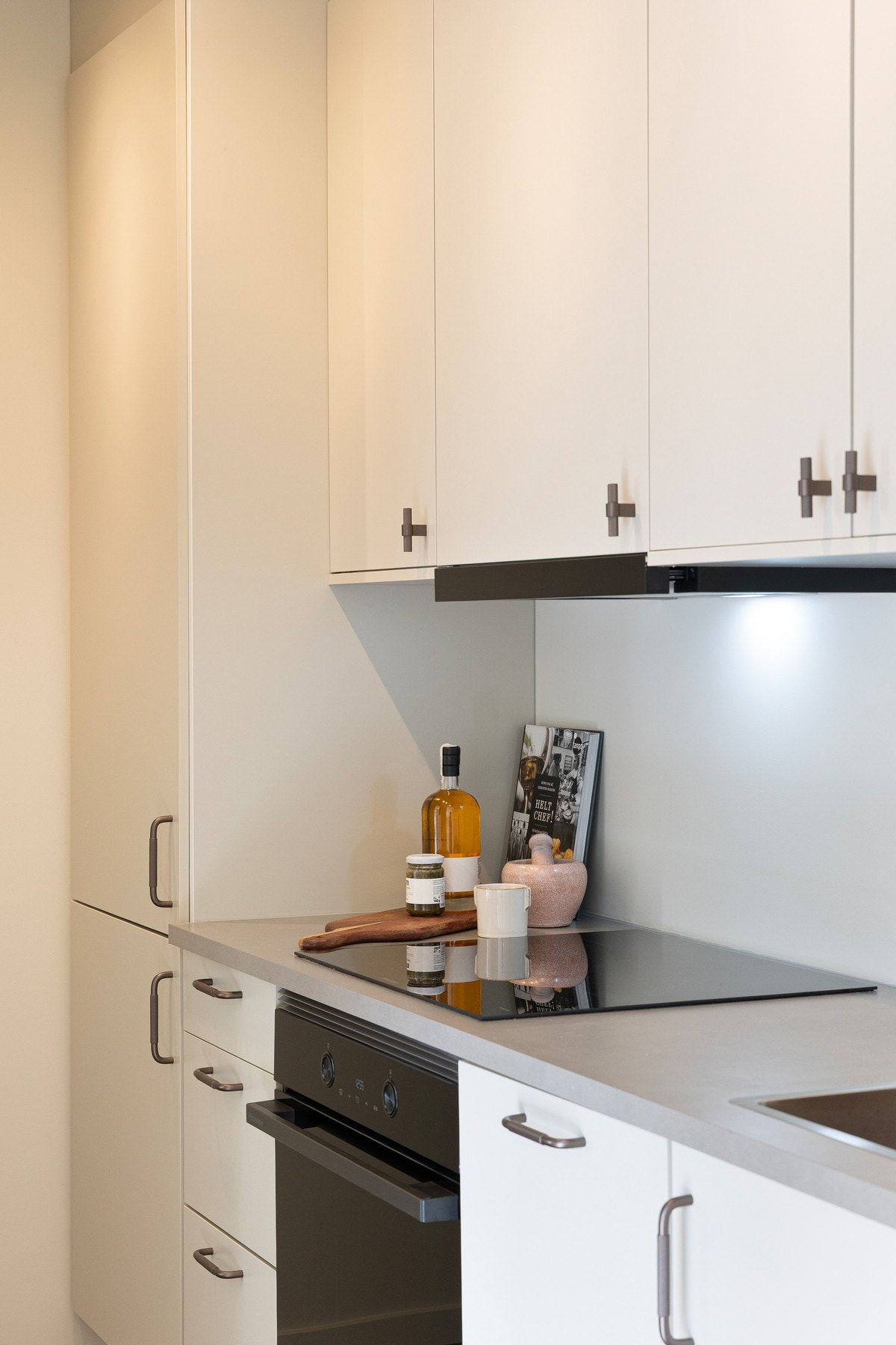 Kjøkkenet ligger i en luftig og åpen løsning mot stue, samtidig tilbaketrukket slik at kjøkkenet ikke blir for dominerende i TV-stuen. Galleribilde