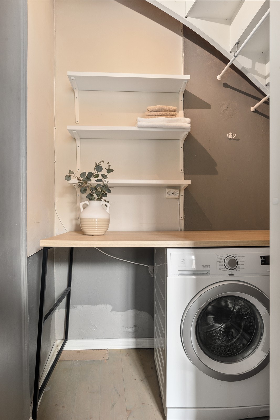 Praktisk trapperom med romslige hyller for oppbevaring og vaskemaskin Galleribilde