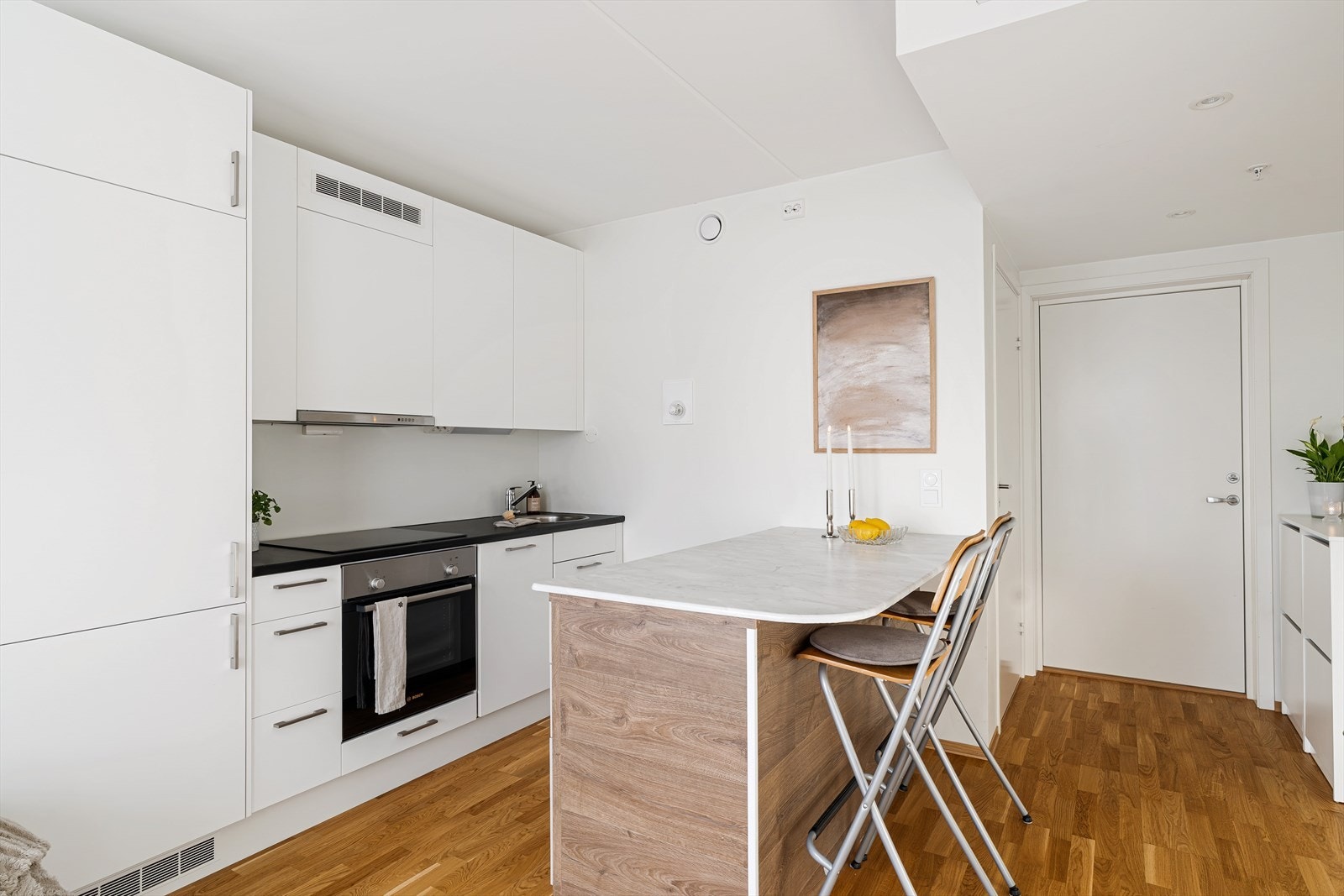 Praktisk kjøkkenøy som gir ekstra oppbevaringsplass og et naturlig skille mellom sonene. Galleribilde