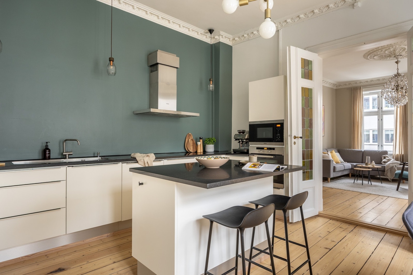 Stor kjøkkenøy fungerer som et naturlig samlingspunkt i leiligheten. Galleribilde