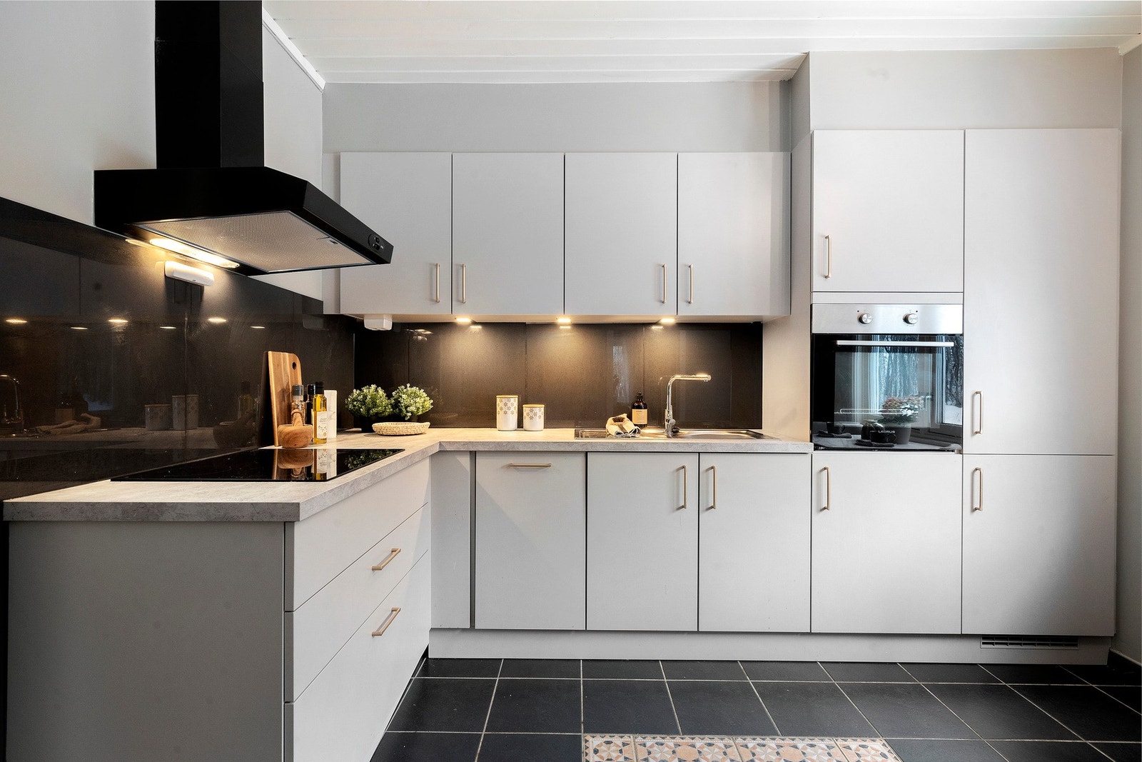 Innredningen har slette fronter, laminat benkeplate og integrerte hvitevarer Galleribilde