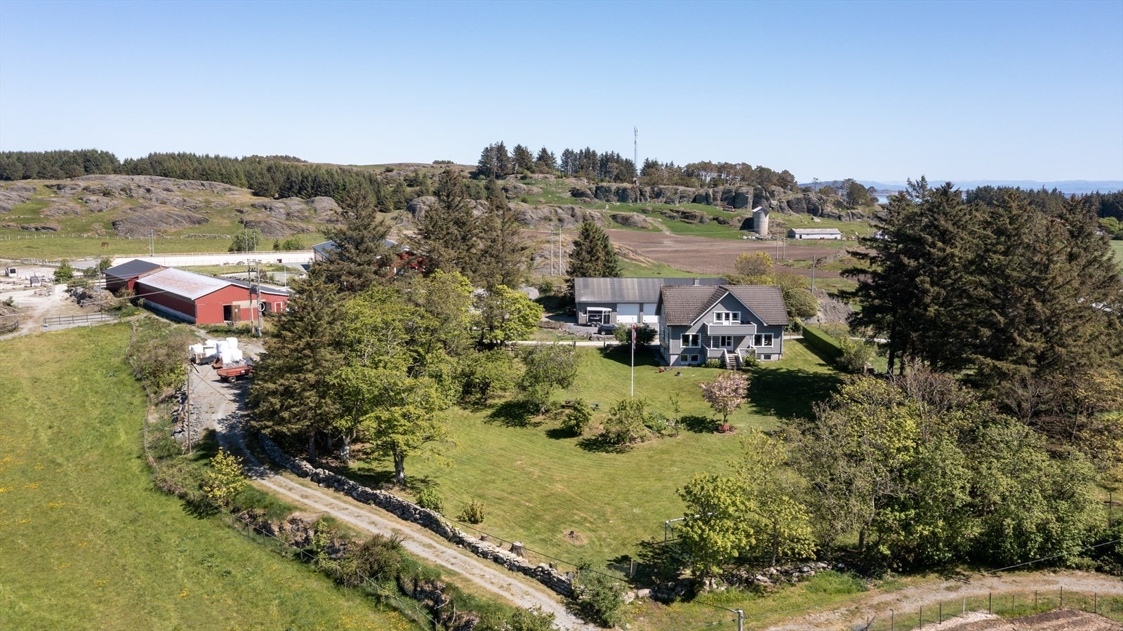 Eiendommen består av innholdsrik enebolig, stall, stort garasje/verkstedbygg, ridehall og ridebane Galleribilde