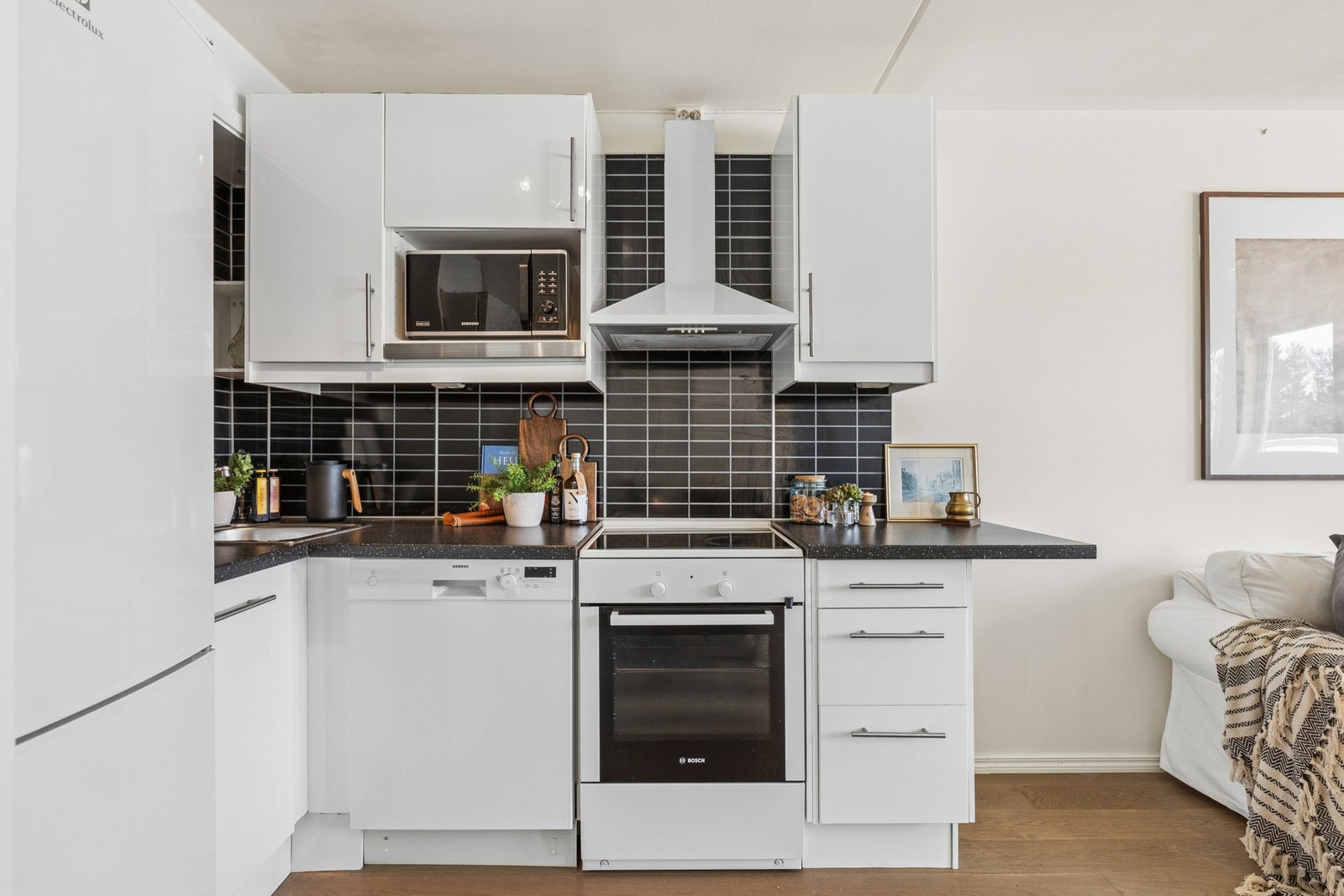 Kjøkkenet har frittstående komfyr, oppvaskmaskin og kjøleskap med fryser. Vegghengt kullfilter ventilator. Galleribilde