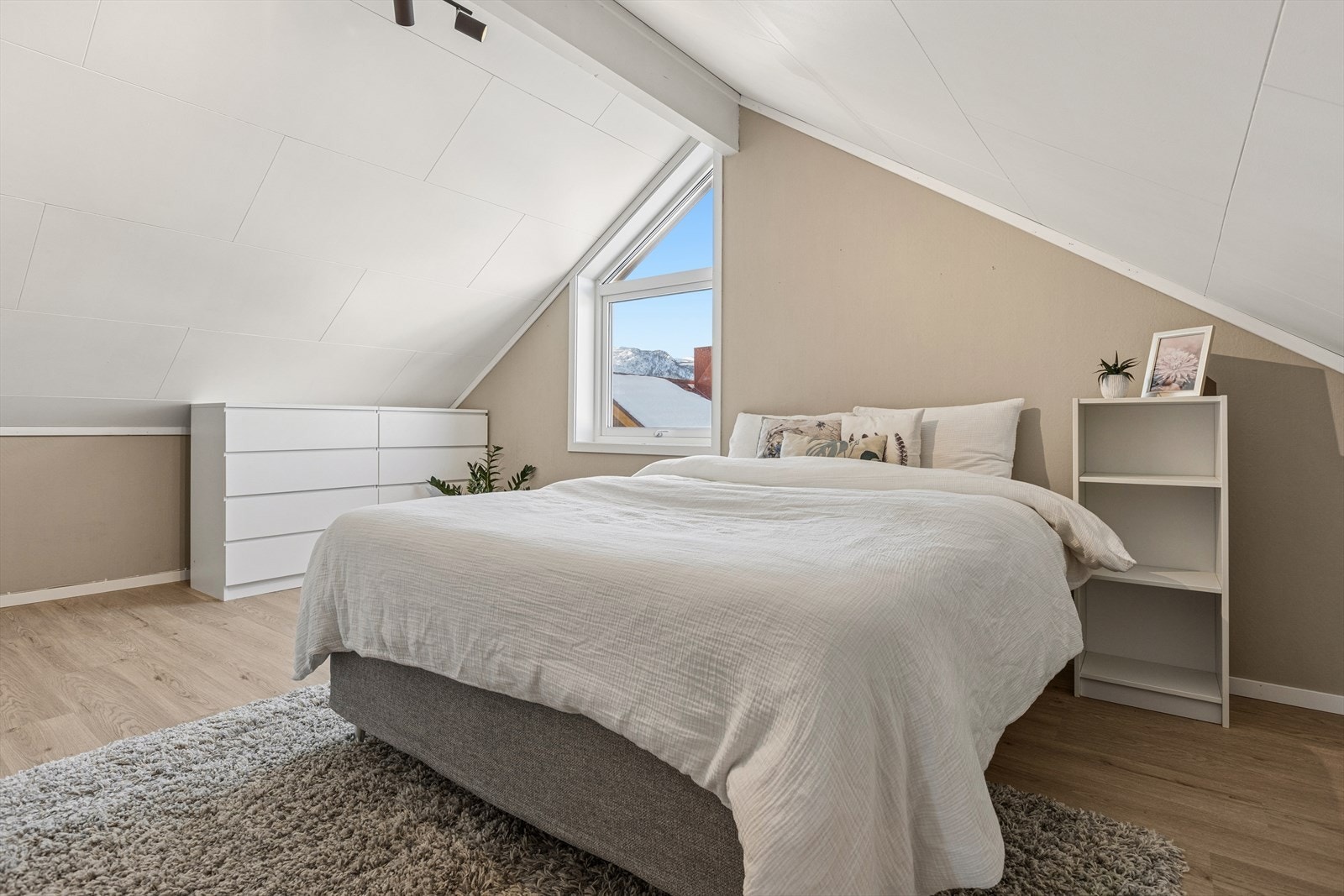 Hovedsoverommet på loftet er romslig og byr på god plass for dobbeltseng, nattbord og garderobeløsninger. Galleribilde