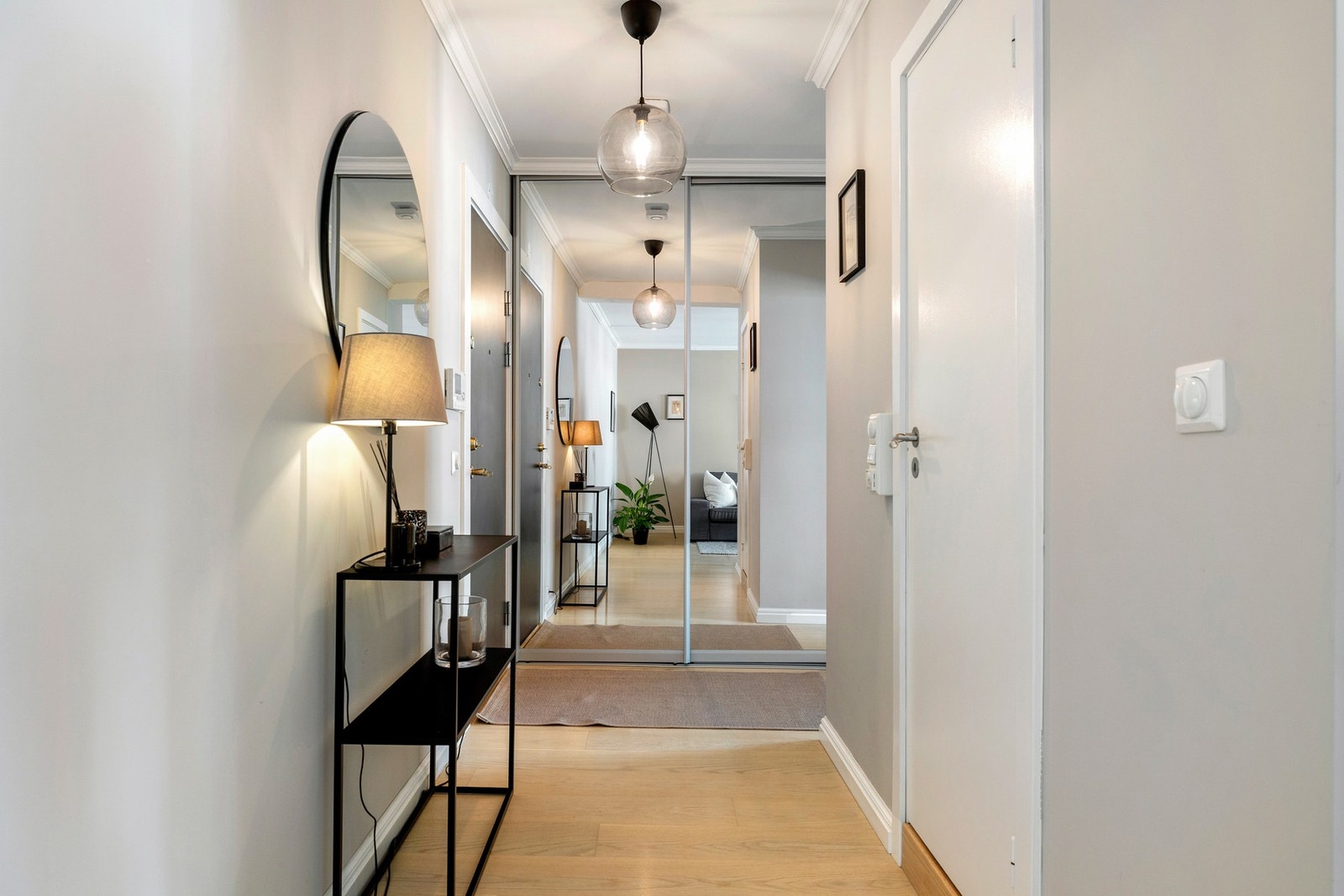 Her har du rikelig med plass til yttertøy og sko i i en romslig skyvedørsgarderobe med speilfronter. Fra entréen er det praktisk adkomst til boligens øvrige rom. Galleribilde