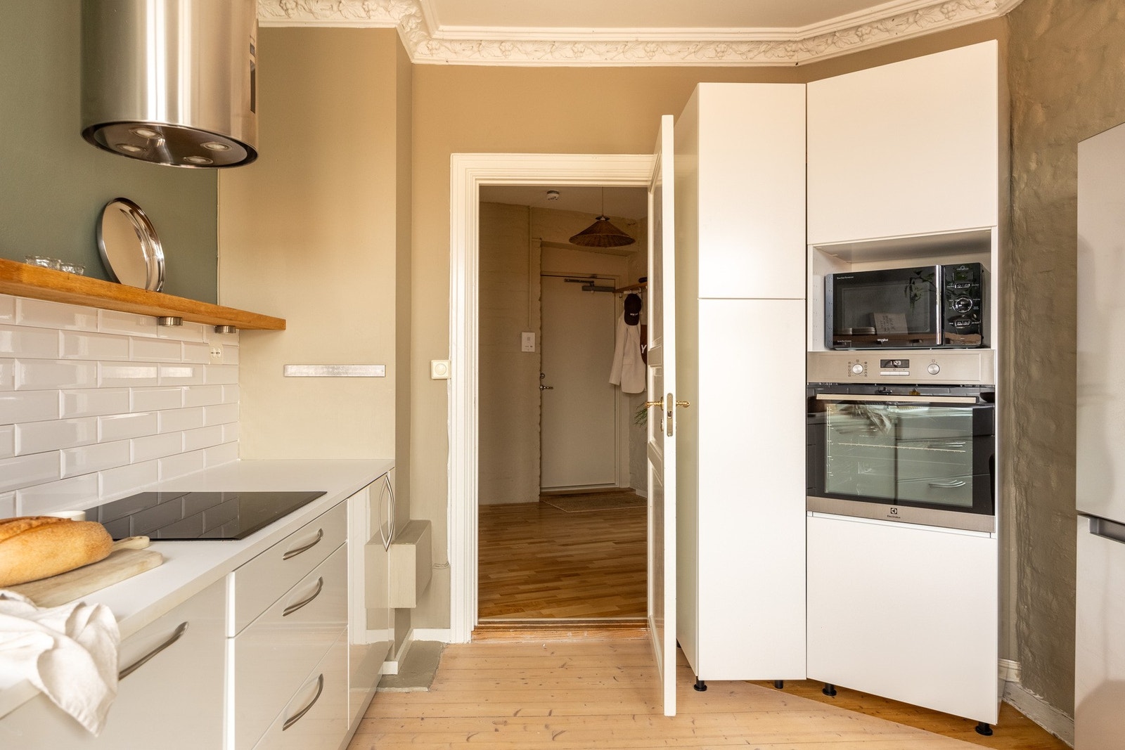 Integrerte hvitevarer som stekeovn, platetopp og oppvaskmaskin, samt fritthengende ventilator. Galleribilde