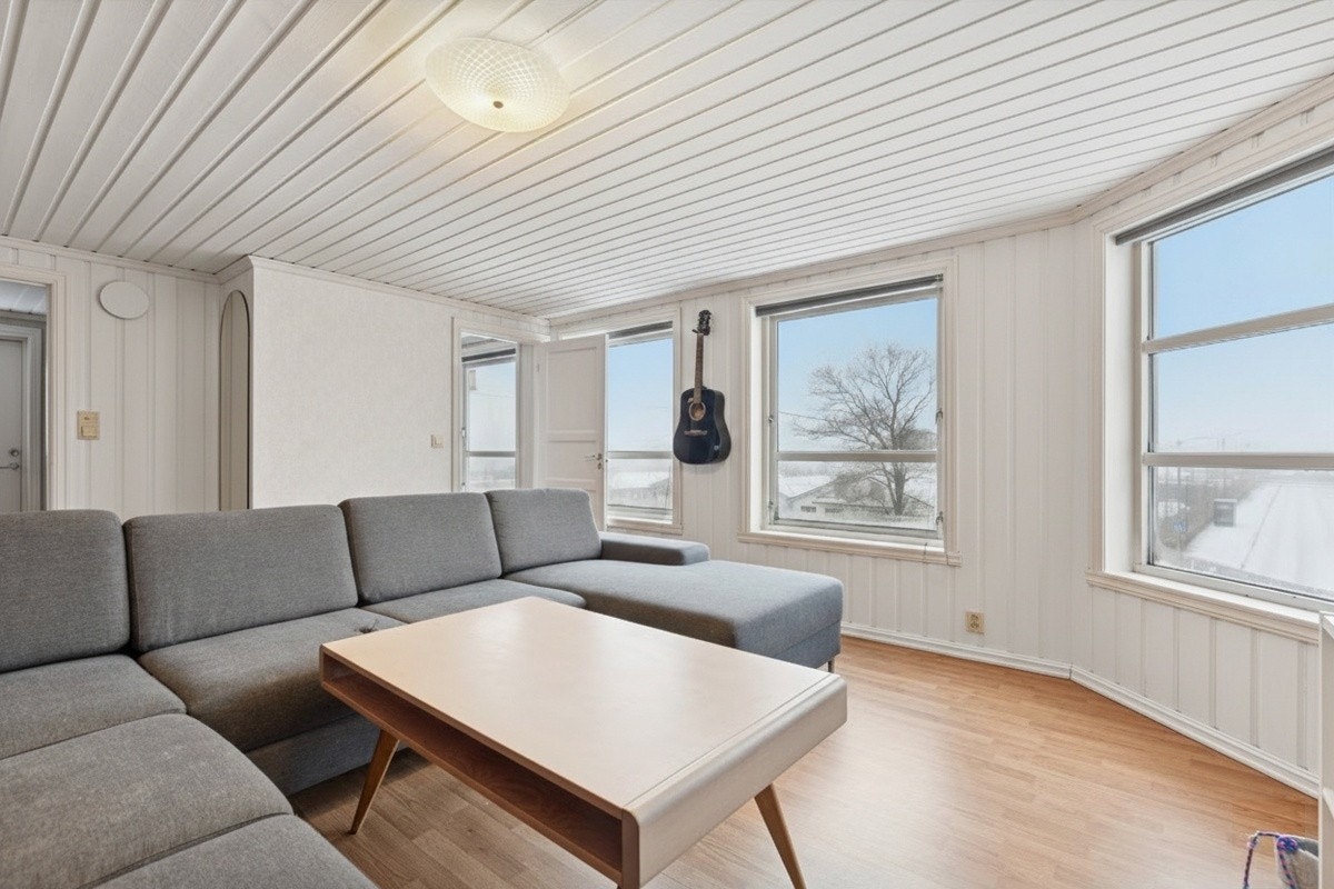 Store vinduer gir rikelig med naturlig lys til stue. Galleribilde