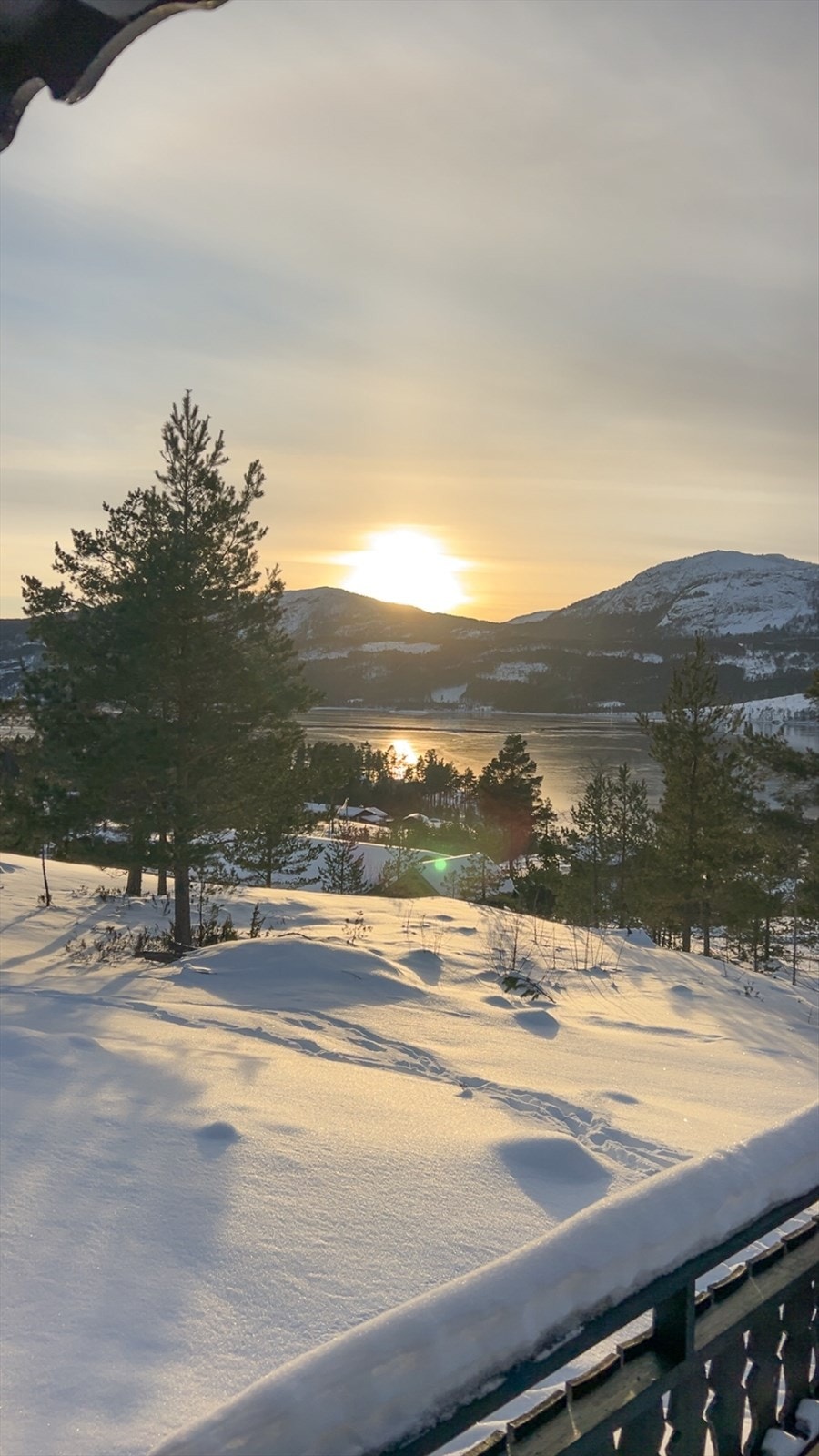 Solnedgangen skaper et idyllisk landskap over vannet og fjellene. Galleribilde