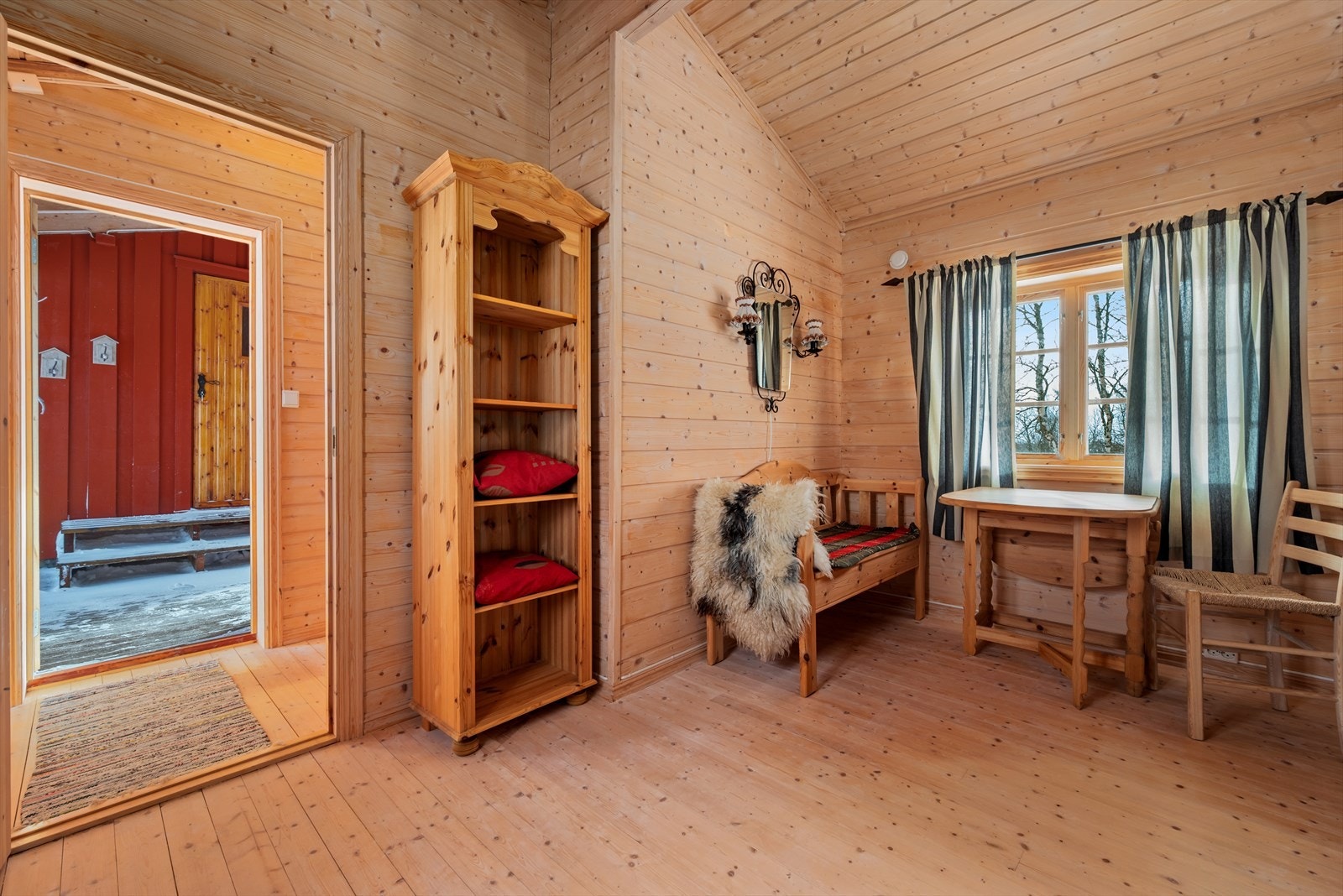 Inngangen er overbygd, og binder hytta sammen med et uthus/anneks på ca. 17 kvm. Galleribilde