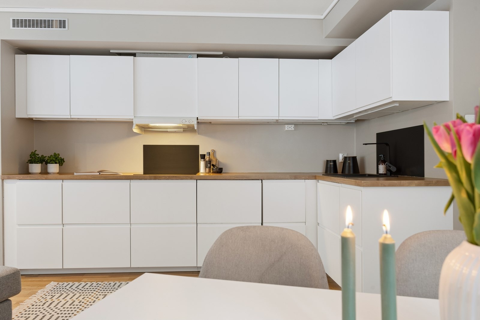 Kjøkkenet fra 2020 har slette fronter med en benkeplate i heltre. Her får du god skapplass og godt med benkeplass. Galleribilde