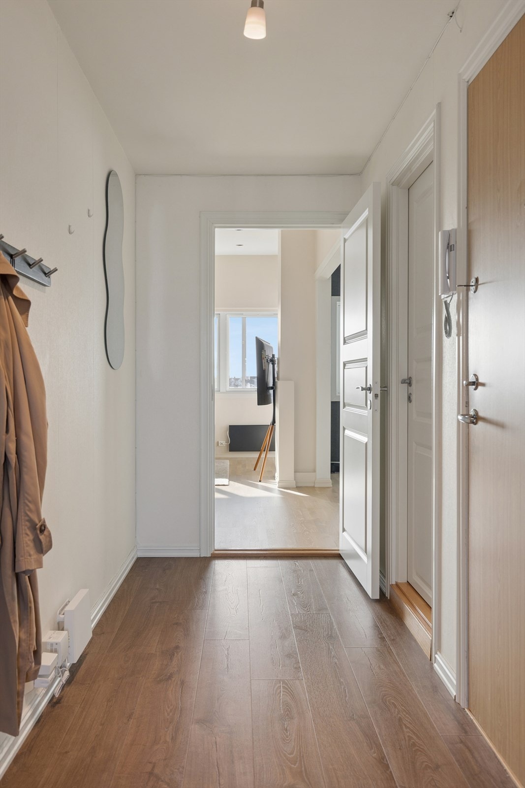 Lys og fin entré med oppheng til yttertøy. Porttelefon. Galleribilde