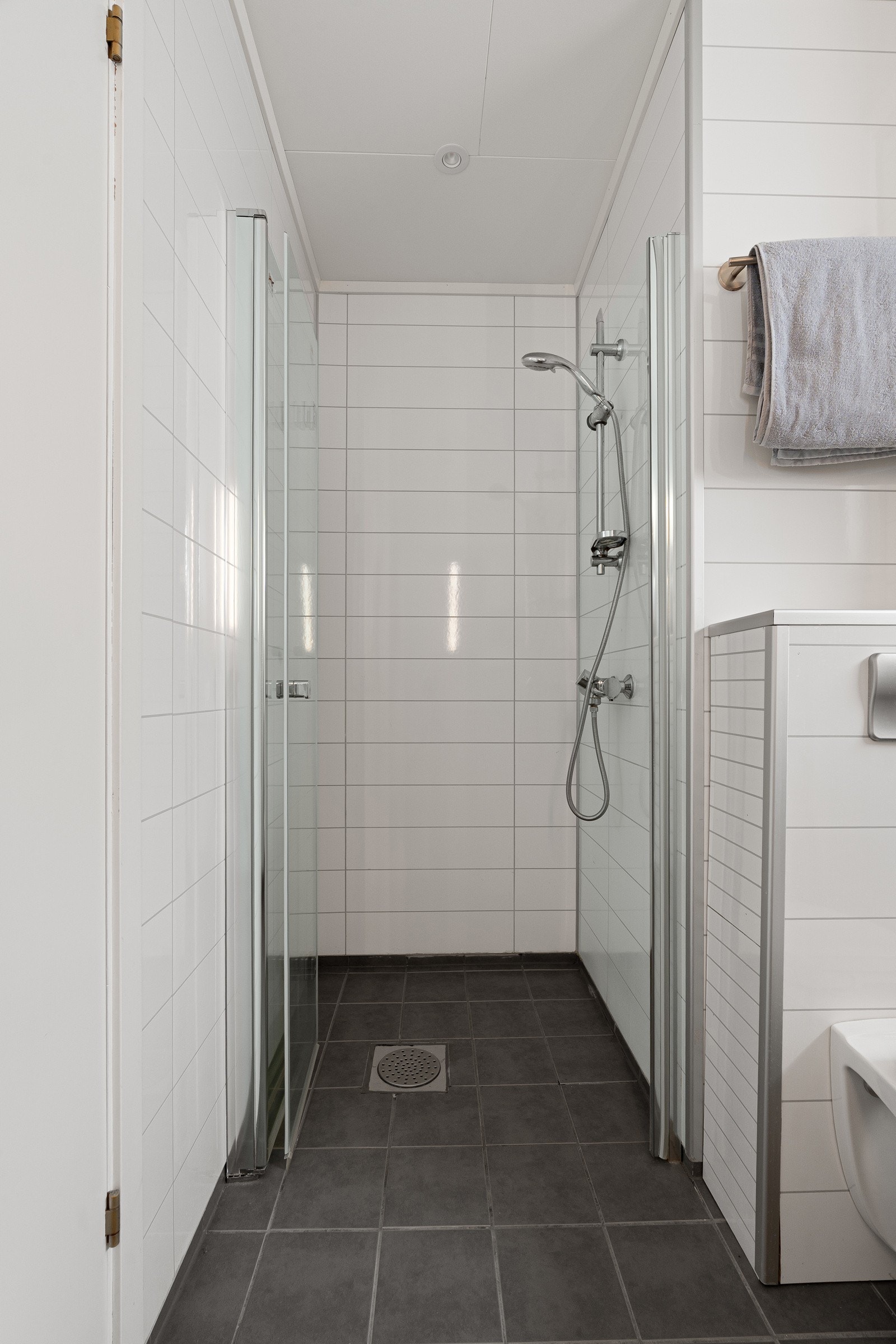 Hovedbad med gulvvarme, lys baderomsinrnedning m/ speilskap og dusjhjørne med innfellbar glassdør. Galleribilde