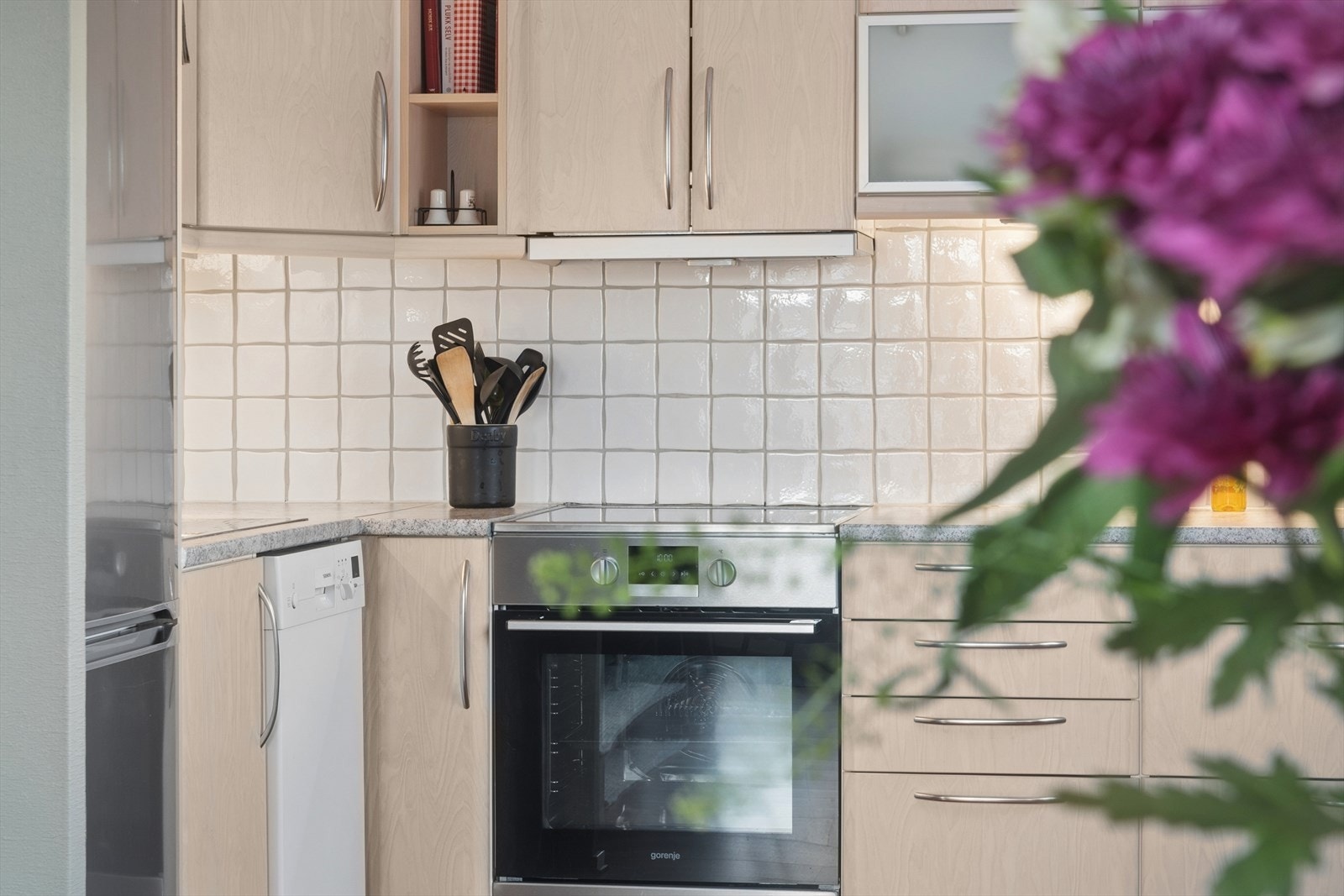 Innredningen har slette fronter og vitrineskap, benkeplate i laminat med nedfelt servant, og plass for kjøleskap, oppvaskmaskin og komfyr. Galleribilde