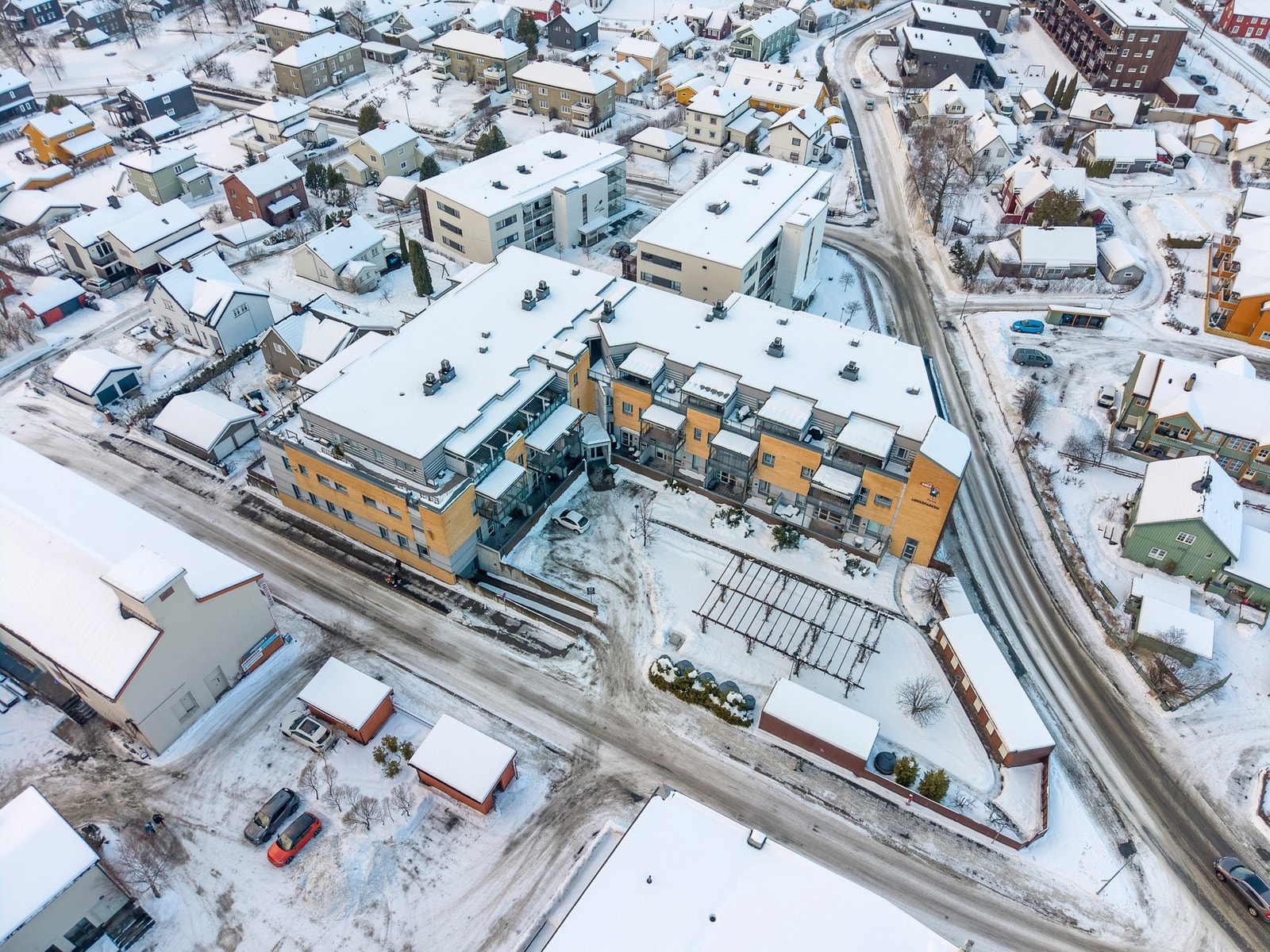 Luftfoto av boligkomplekset som viser intern gårdsplass og sentral plassering i nærområdet. Galleribilde