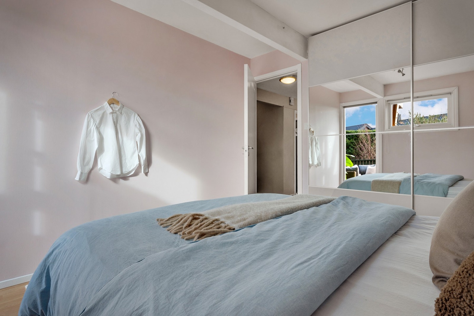 Rommet har et innhukk med garderobeskap med skyvedører med speilfronter. Galleribilde