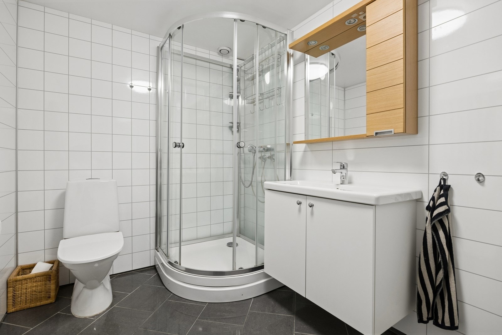 Delikat bad på 5 kvm fra 2012 med moderne fliser, god belysning og funksjonell innredning. Galleribilde