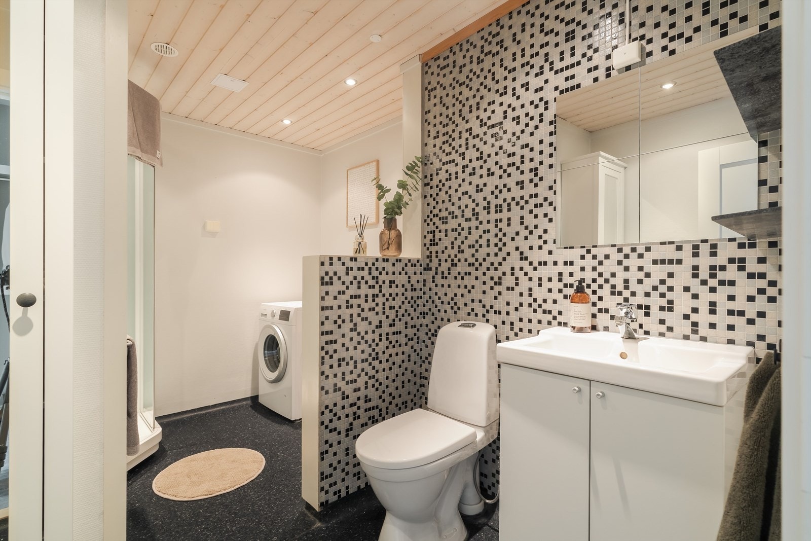 Badet er på 7m² og har servant på underskap, wc, opplegg for vaskemaskin og dusjkabinett. Galleribilde