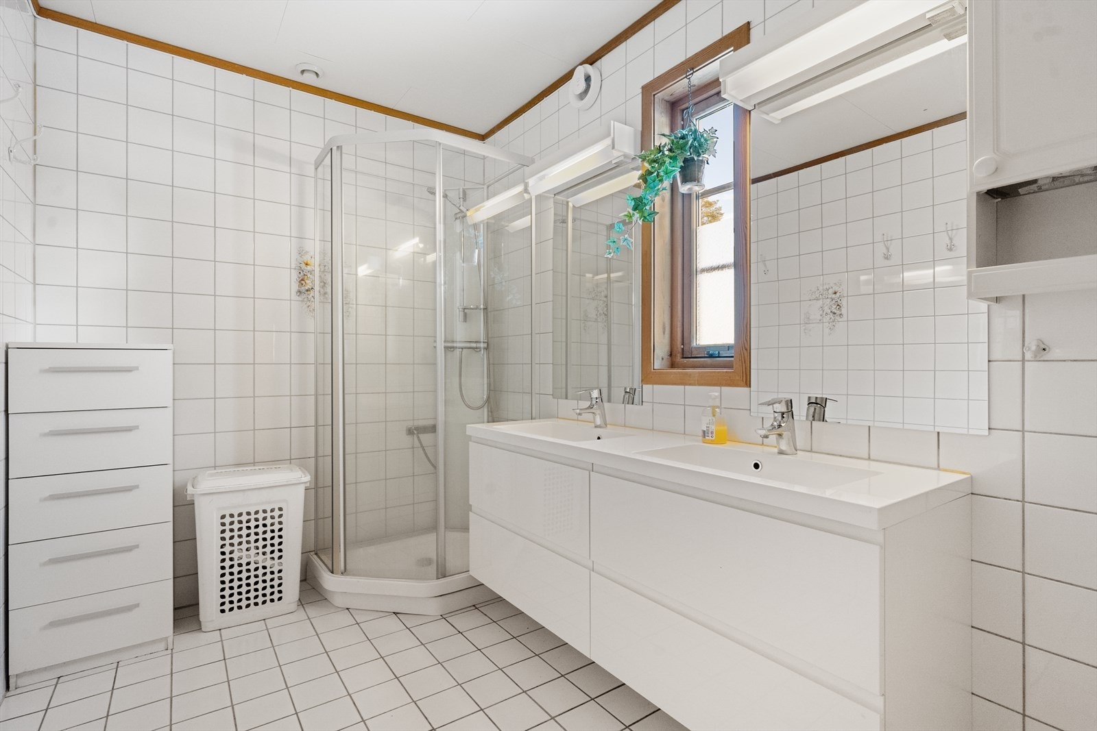 Badet er utstyrt med dusjkabinett og har fliser på gulv og vegger. Det er varme i gulvet for ekstra komfort. Galleribilde