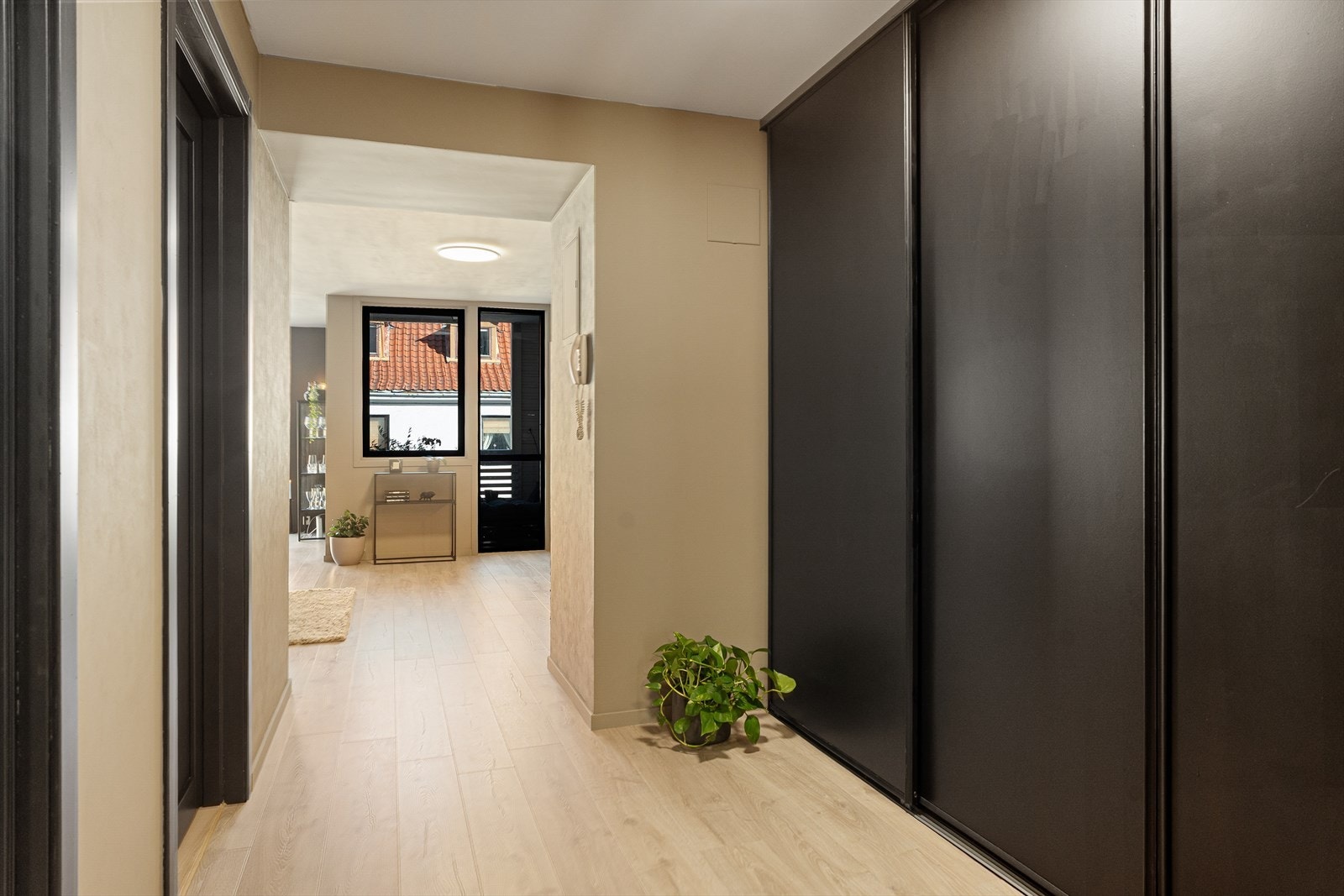 Entréen og gangen gir et fint førsteinntrykk. Her er god plass til yttertøy og sko i romslig skyvedørsgarderobe og bod. Porttelefon. Galleribilde