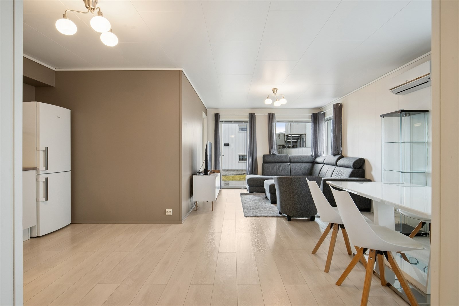 Den åpne løsningen gir fleksible møbleringsmuligheter for både en sofagruppe og et romslig spisebord. Galleribilde