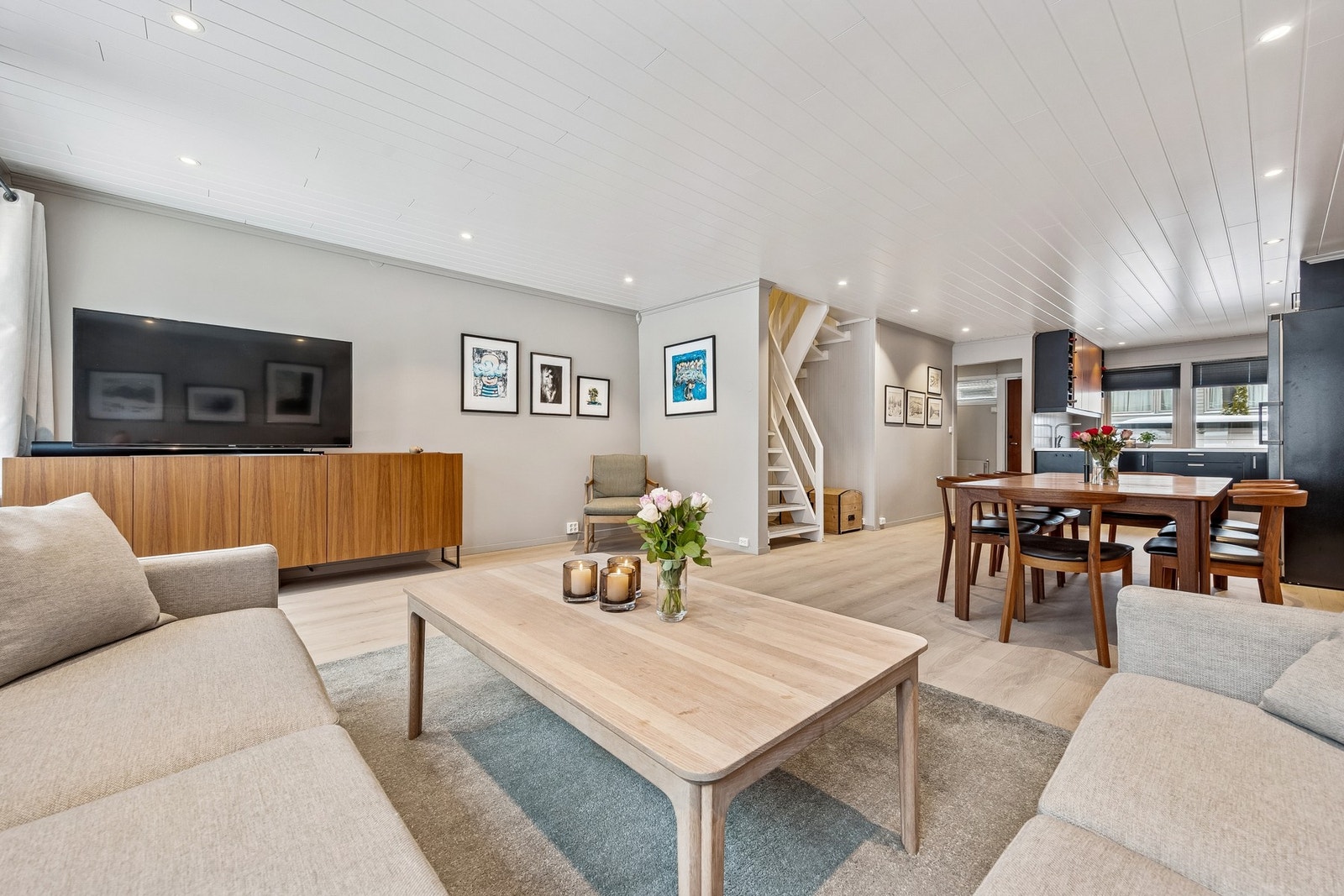 Stuen er malt i en lys, nøytral farge som gjør det lett å sette sitt personlige preg på rommet gjennom pynt og interiør Galleribilde