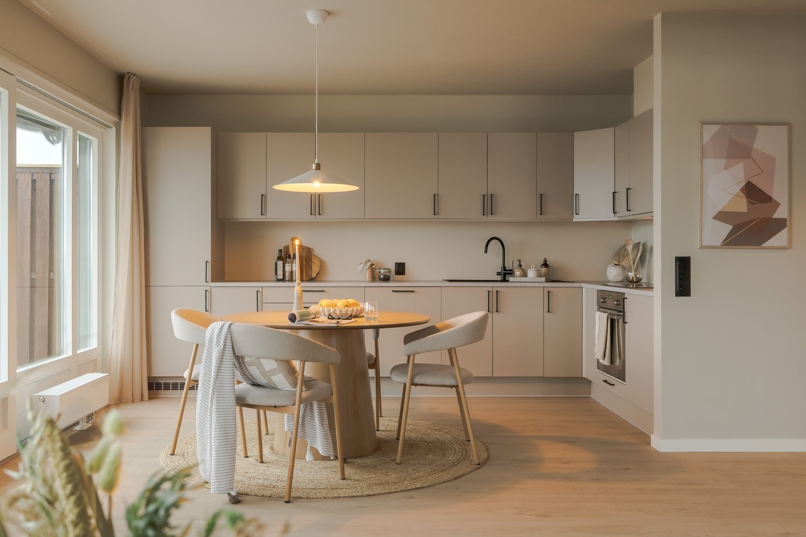 Kjøkkenet er stilrent og moderne, oppført i en funksjonell L-form med god arbeidsflyt og skapplass. Galleribilde