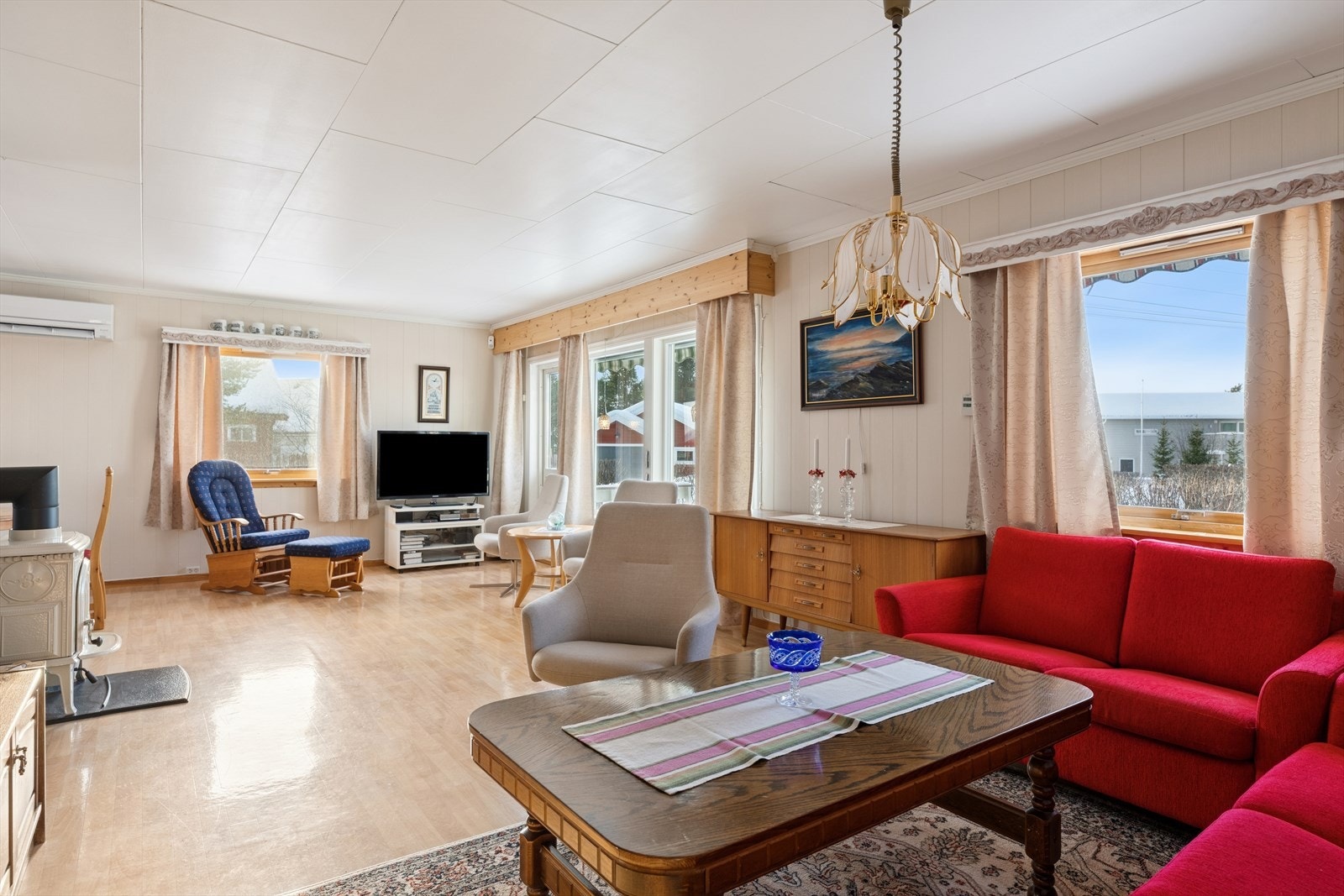 Store vindusflater slipper inn rikelig med dagslys og gir rommet en lys, åpen og luftig atmosfære. Galleribilde