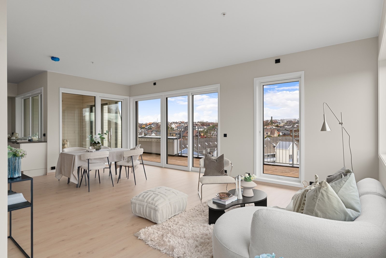 Leilighetens stue fremstår som lys og trivelig med store vindusflater som slipper inn mye naturlig lys som er med på å skape en god romfølelse og atmosfære. Galleribilde