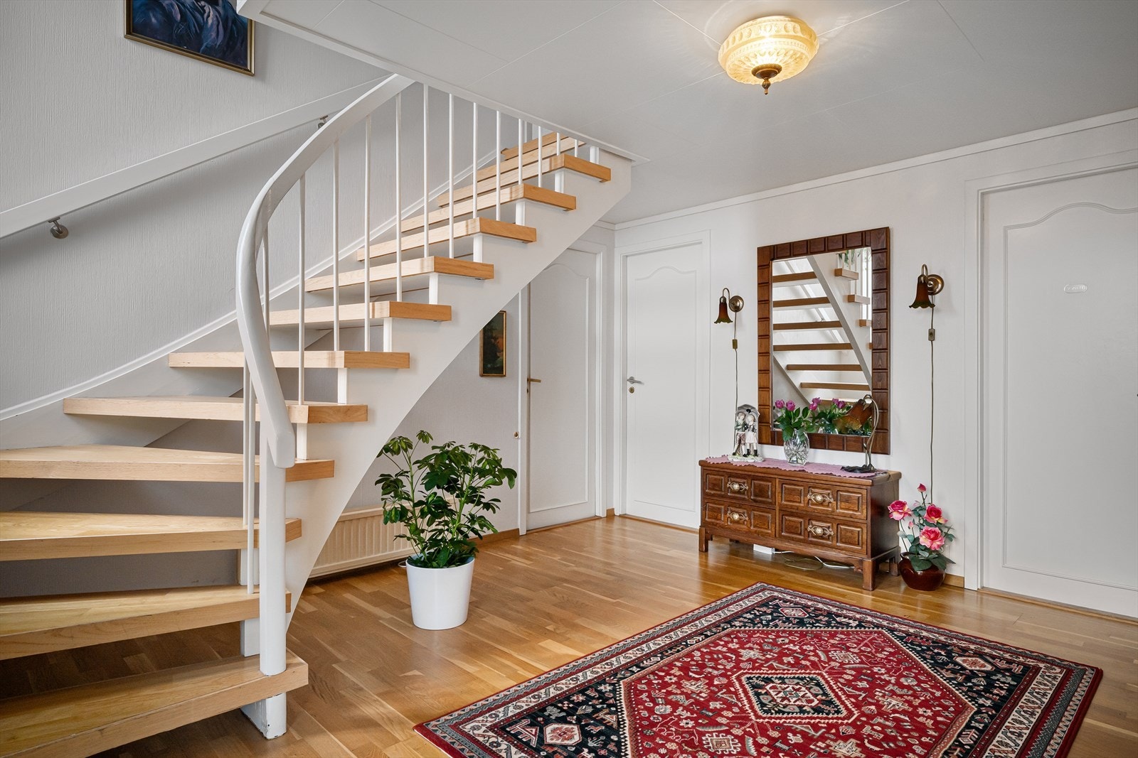 Romslig hall med god plass til sittegruppe, påkledningsbenk, kommoder og oppheng. Galleribilde