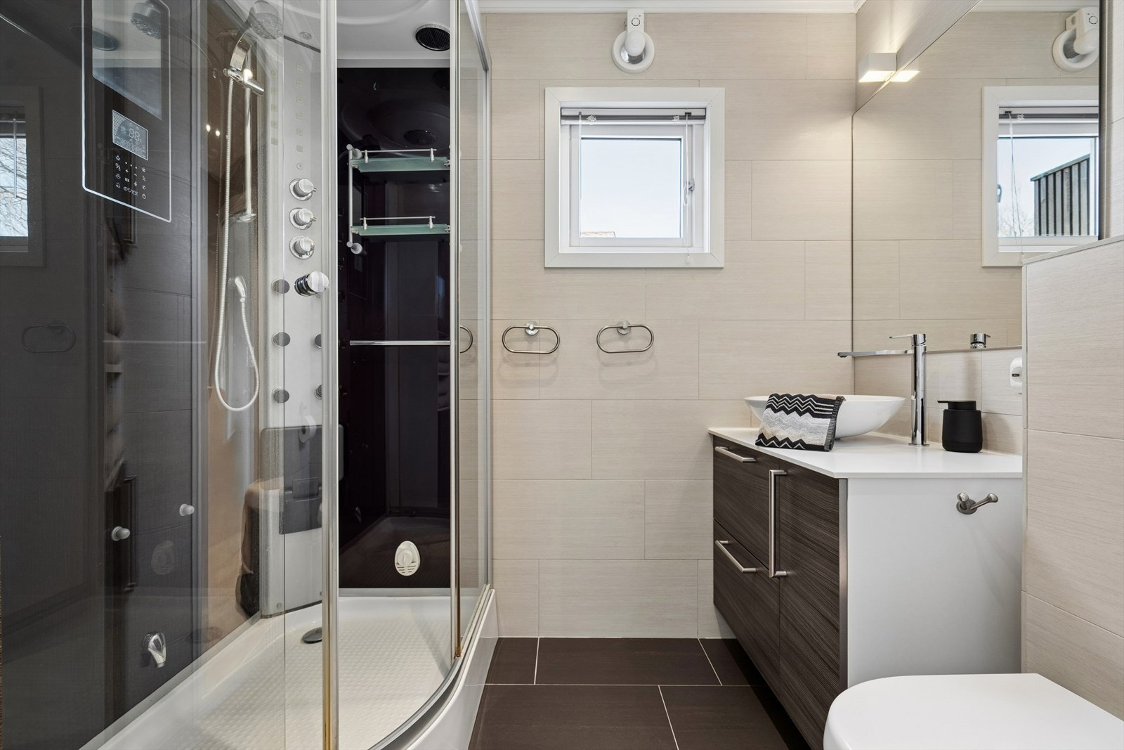 Badet ble oppgradert i 2010 og har flislagte overflater i tidløse farger. Her finner du steamdusj(kabinett), vegghengt toalett og baderomsinnredning Galleribilde