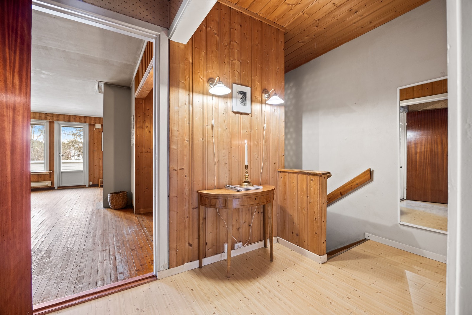 Entréen kombinerer fliser ved inngangsdøren, laminat i mellomgangen, malt strie og originale paneler. Galleribilde